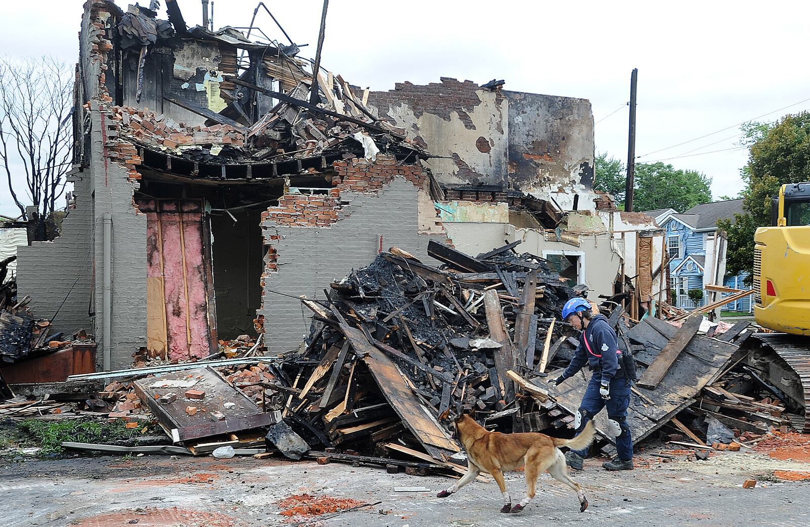 Fire destroyed three houses on East Fourth Street in Dayton Monday morning, June 6, 2024, resulting in an emergency demolition order. A cadaver dog was brought in from Columbus to check the ruins as a precaution. MARSHALL GORBY\STAFF