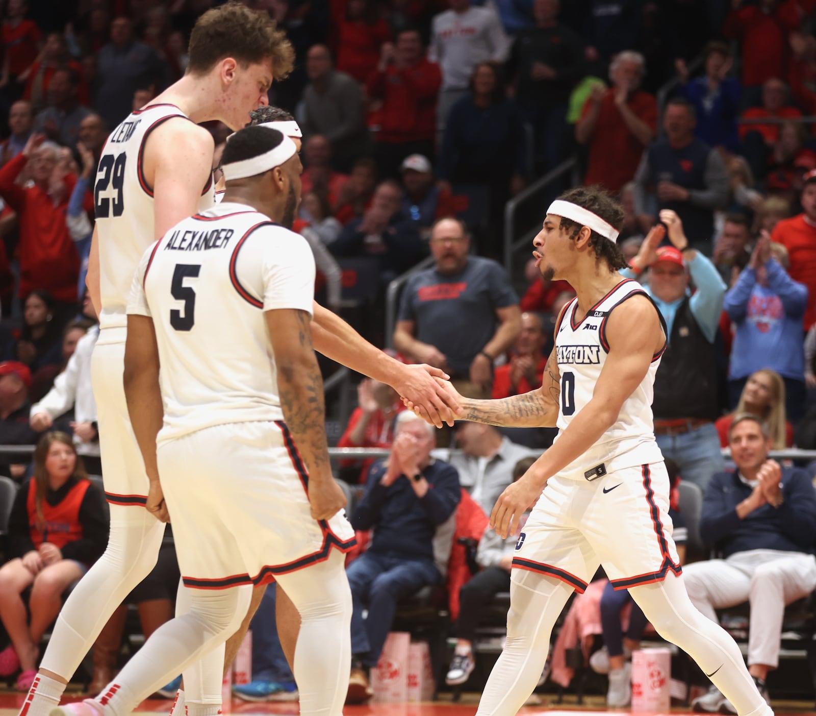 Dayton's Javon Bennett, right, reacts after making the go-ahead layup and drawing a foul in the final minute against Davidson on Tuesday, Feb. 4, 2025, at UD Arena.. David Jablonski/Staff