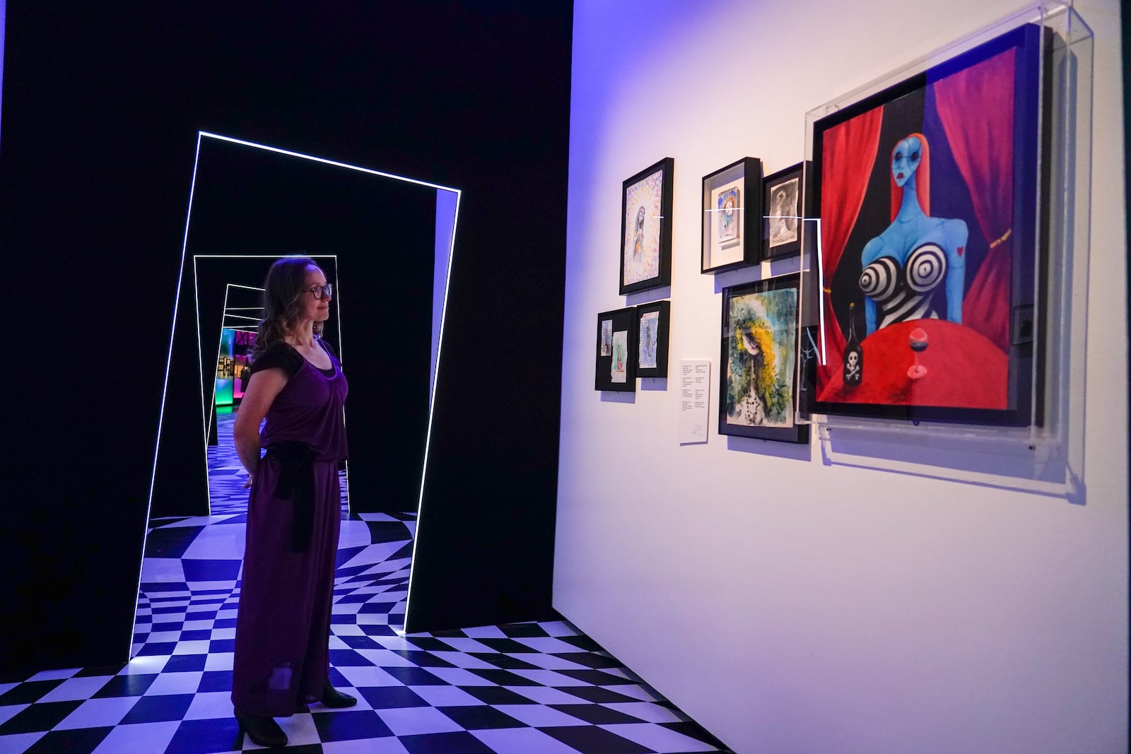 A member of staff poses at The World of Tim Burton exhibition at the Design Museum, in London, Monday, Oct. 21, 2024. The major exhibition sees Tim Burton's personal archives on display for the first time, featuring 600 items from his nearly fifty years long career. (AP Photo/Alberto Pezzali)