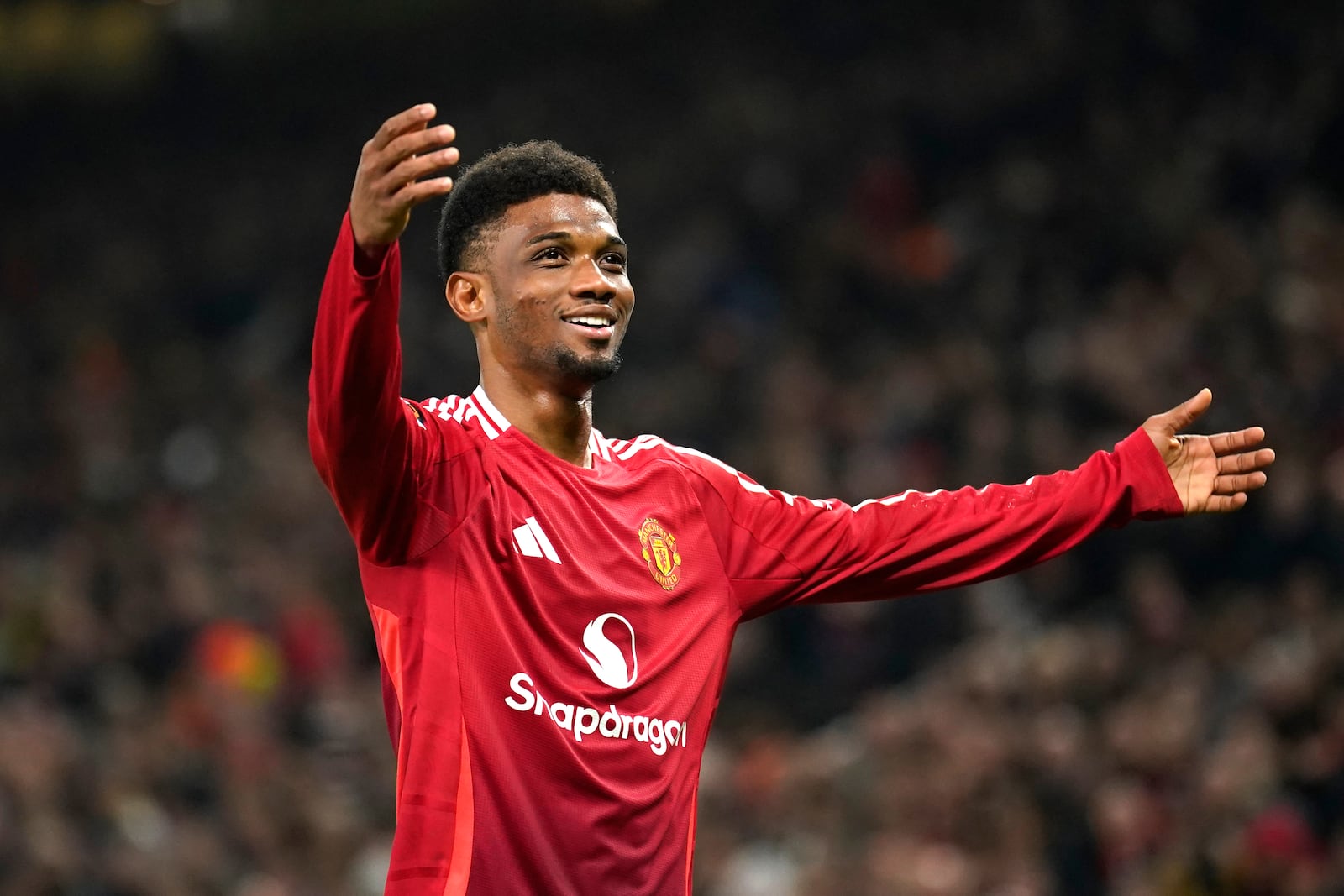 Manchester United's Amad Diallo celebrates after scoring his side's second goal during the Europa League opening phase soccer match between Manchester United and PAOK at the Old Trafford stadium in Manchester, England, Thursday, Nov. 7, 2024. (AP Photo/Dave Thompson)