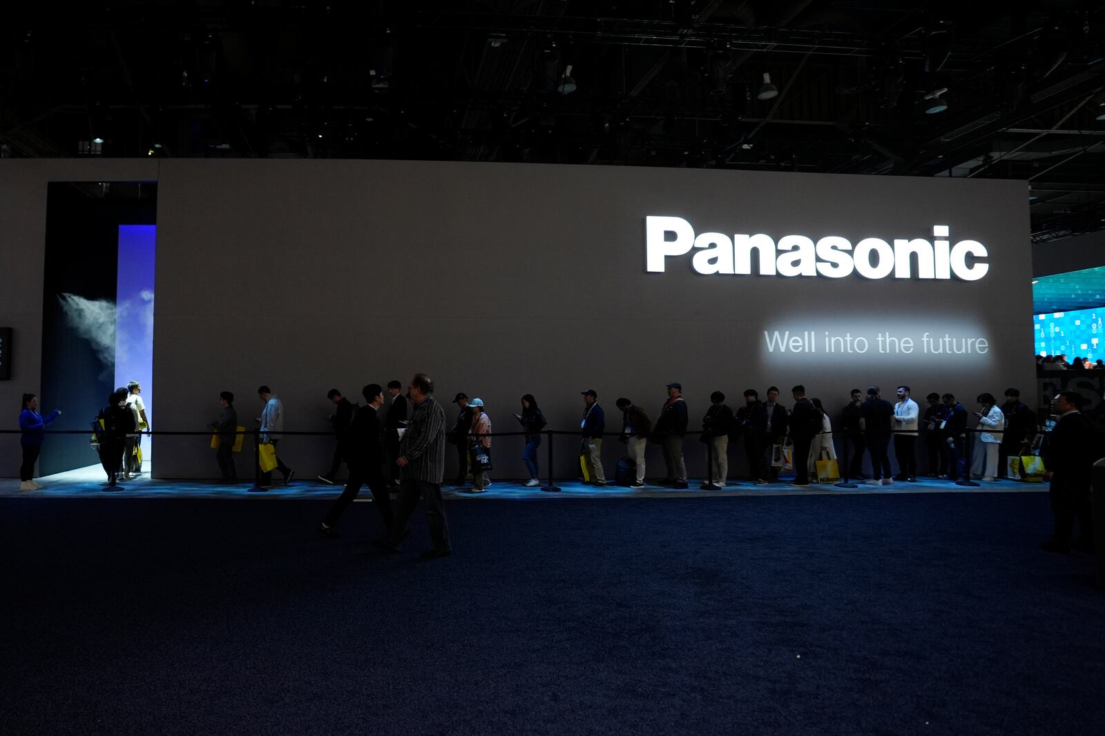 People wait in line to enter a Panasonic booth during the CES tech show Tuesday, Jan. 7, 2025, in Las Vegas. (AP Photo/Abbie Parr)