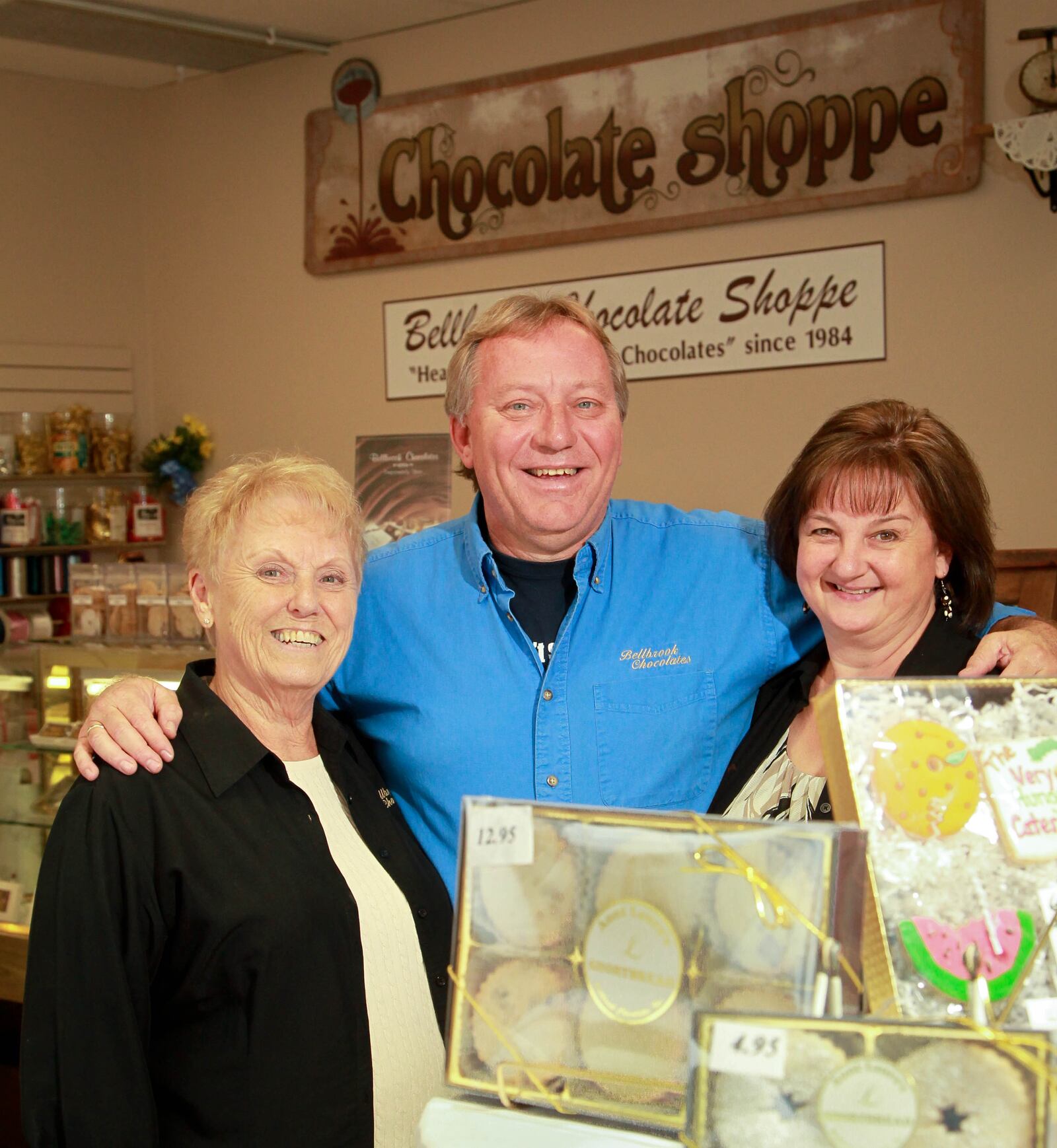 In this 2014 photo, the founder of Bellbrook Chocolate Shoppe,  Betty Blose (left), stands with her son Marshall Blose and Laura Blose in the family business located in the Cross Pointe Center. FILE PHOTO BY JIM WITMER