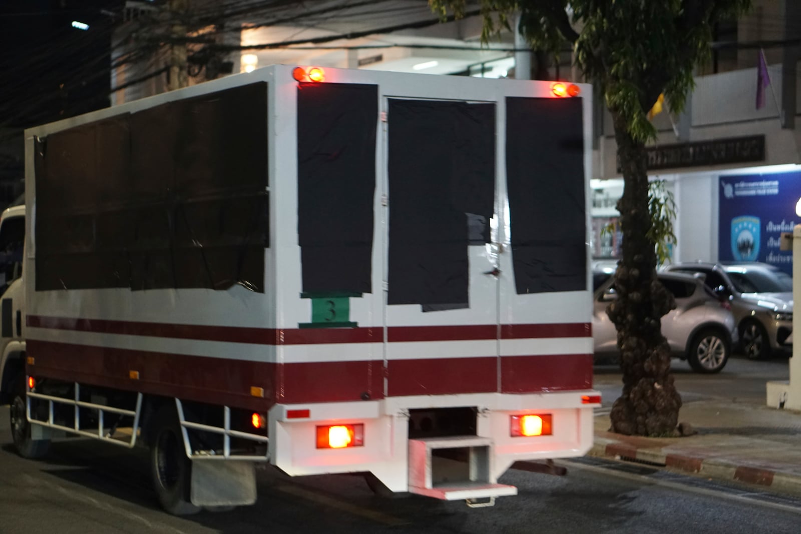 This photo provided by Thailand's daily web newspaper Prachatai shows trucks with black tape covering the windows leave a detention center in Bangkok, Thailand Thursday, Feb. 27, 2025.(Nuttaphol Meksobhon/Prachatai via AP)