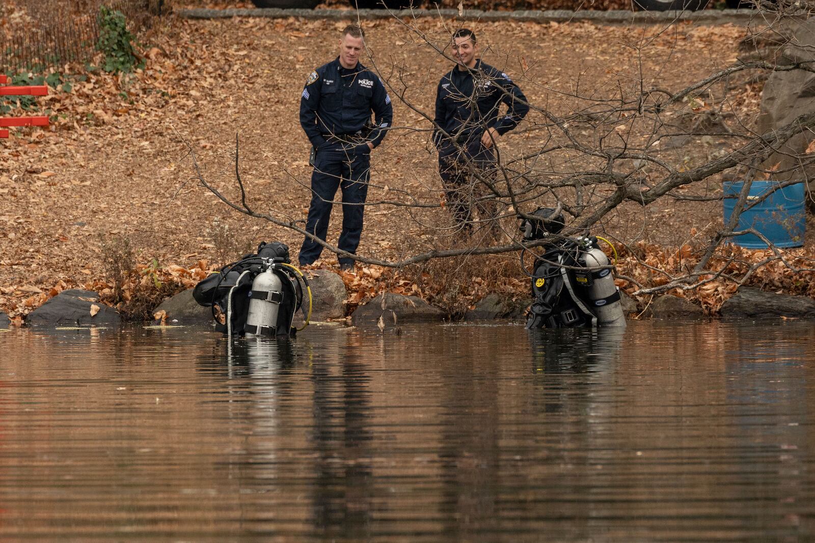 NYPD officers in diving suits search the lake in the Central Park, Monday, Dec. 9, 2024, in New York. (AP Photo/Yuki Iwamura)