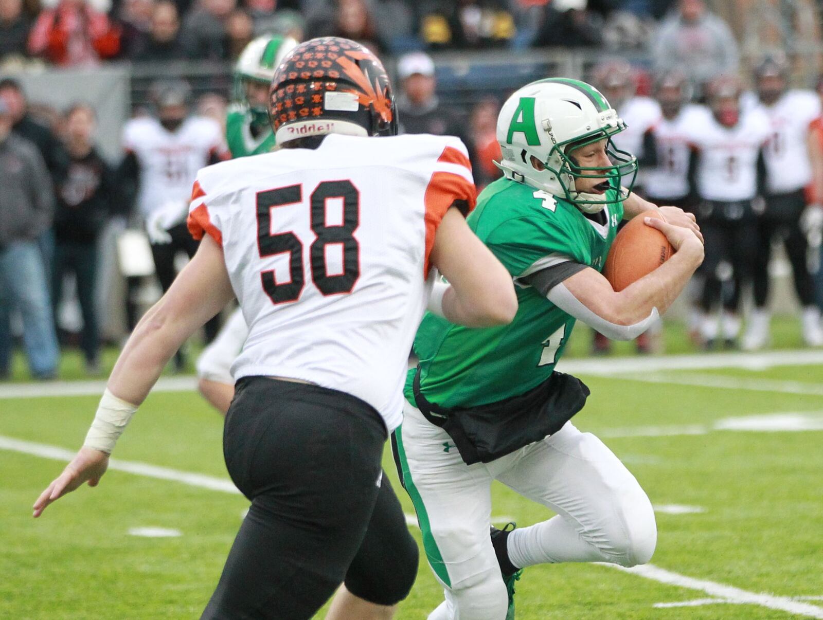 Anna quarterback Bart Bixler (with ball) rushed for three touchdowns and passed for another in the Rockets’ 48-14 win over New Middletown Springfield on Friday in the Division VI title game at Tom Benson Hall of Fame Stadium in Canton. Marc Pendleton/STAFF