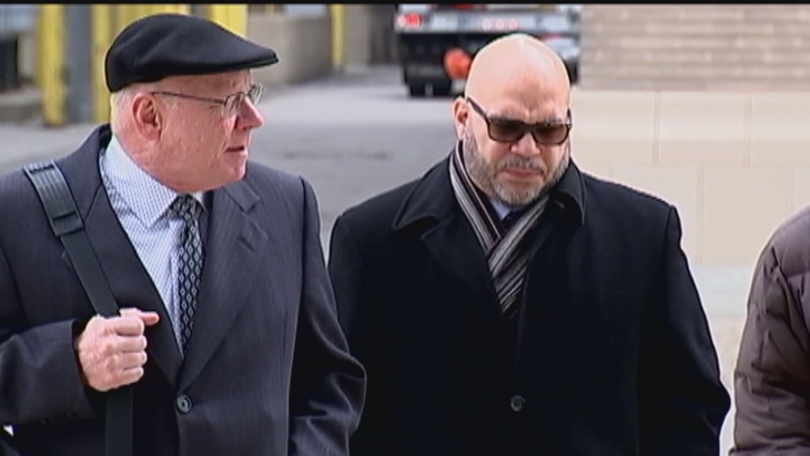 Former Dayton city employee RoShawn Winburn (right) walks with his attorney David P. Williamson outside federal court in Dayton on Tuesday, where Winburn pleaded guilty to corruptly soliciting a bribe. STAFF PHOTO/Chuck Hamlin