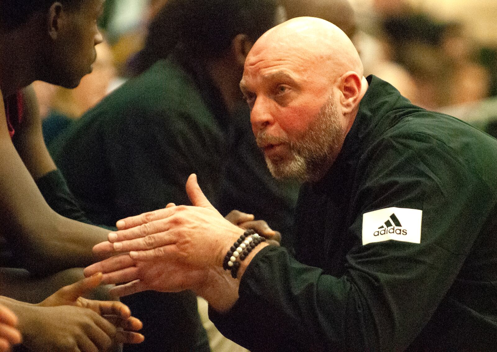 Trotwood-Madison coach Rocky Rockhold talks to players on his bench during the second half of Sunday’s Flyin’ To The Hoop game at Trent Arena against Akron St. Vincent-St. Mary. Jeff Gilbert/CONTRIBUTED