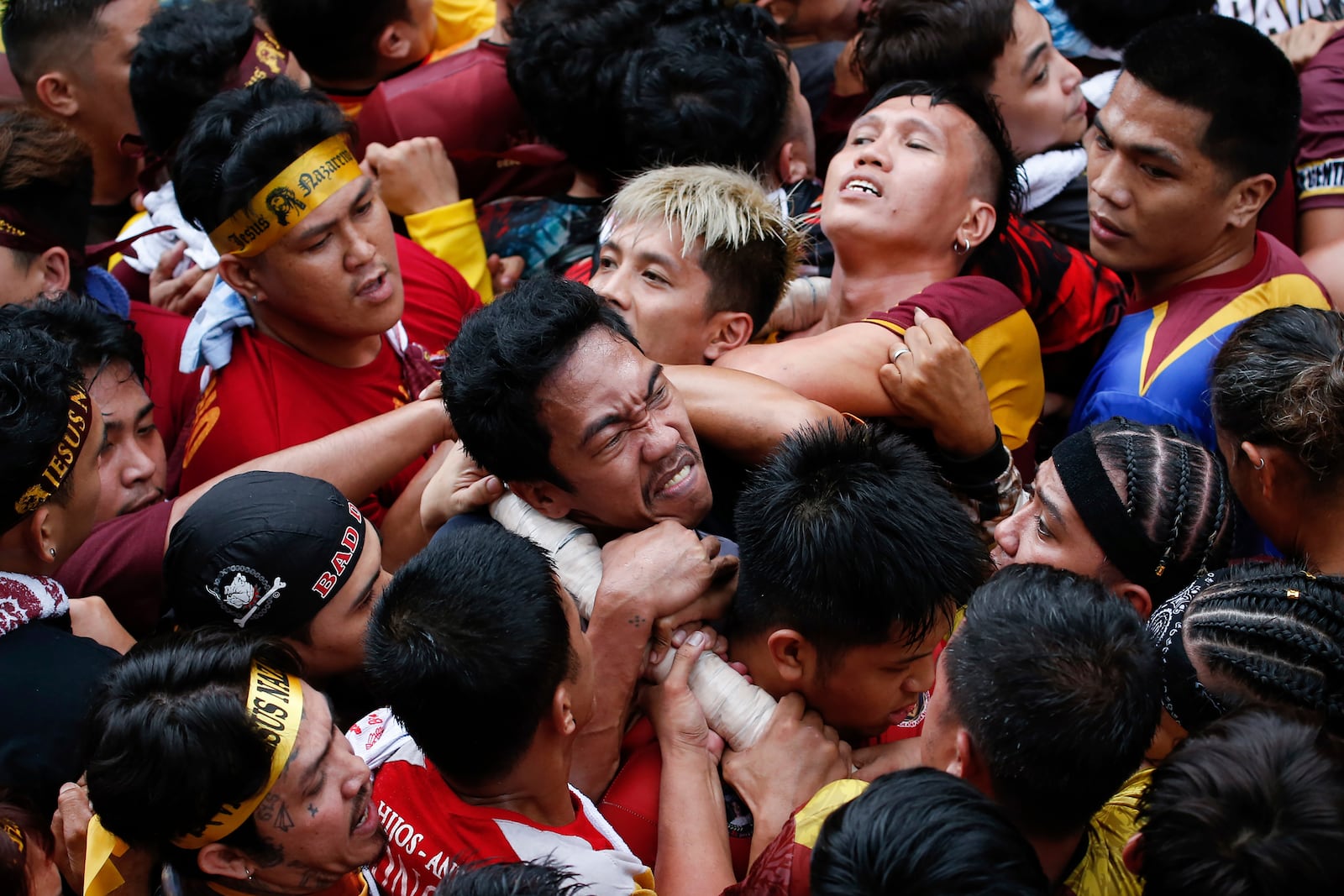 Devotees grab the rope as they pull a glass-covered carriage carrying the image of Jesus Nazareno during its annual procession in Manila, Philippines Thursday, Jan. 9, 2025. (AP Photo/Basilio Sepe)