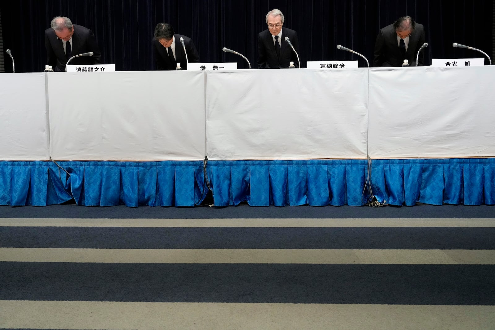 Ryunosuke Endo, from left, vice chairman of the Board of Fuji Television Network, Koichi Minato, president and CEO of Fuji Television Network, Shuji Kano, Fuji Media Holdings COB, Osamu Kanemitsu, president and CEO of Fuji Media Holdings, bow during a news conference at the Fuji Television headquarters in Tokyo, Monday, Jan. 27, 2025. (AP Photo/Eugene Hoshiko)