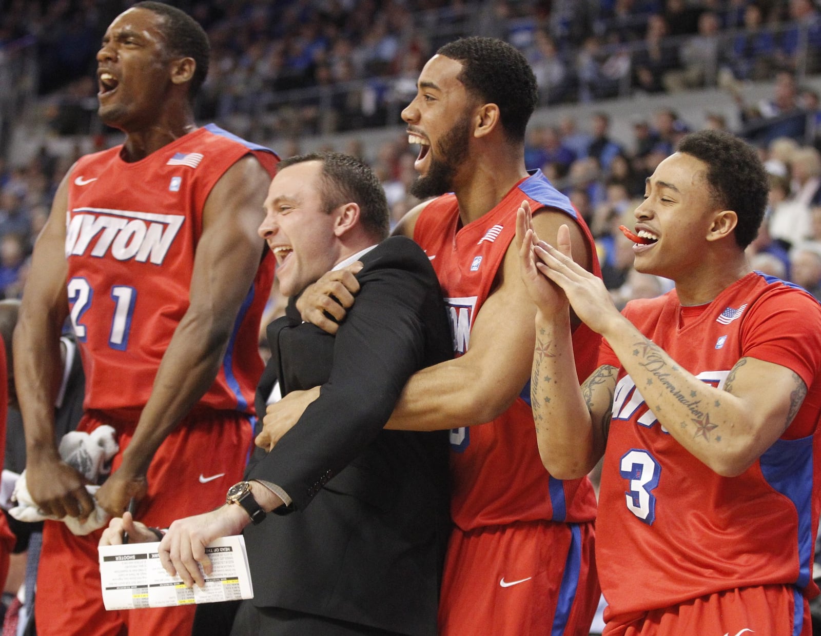 The Dayton bench, including Dyshawn Pierre, left, Eric Farrell, Devon Scott and Kyle Davis, celebrates in the second half on Wednesday, March 5, 2014, at Chaifetz Arena in Saint Louis, Mo. David Jablonski/Staff