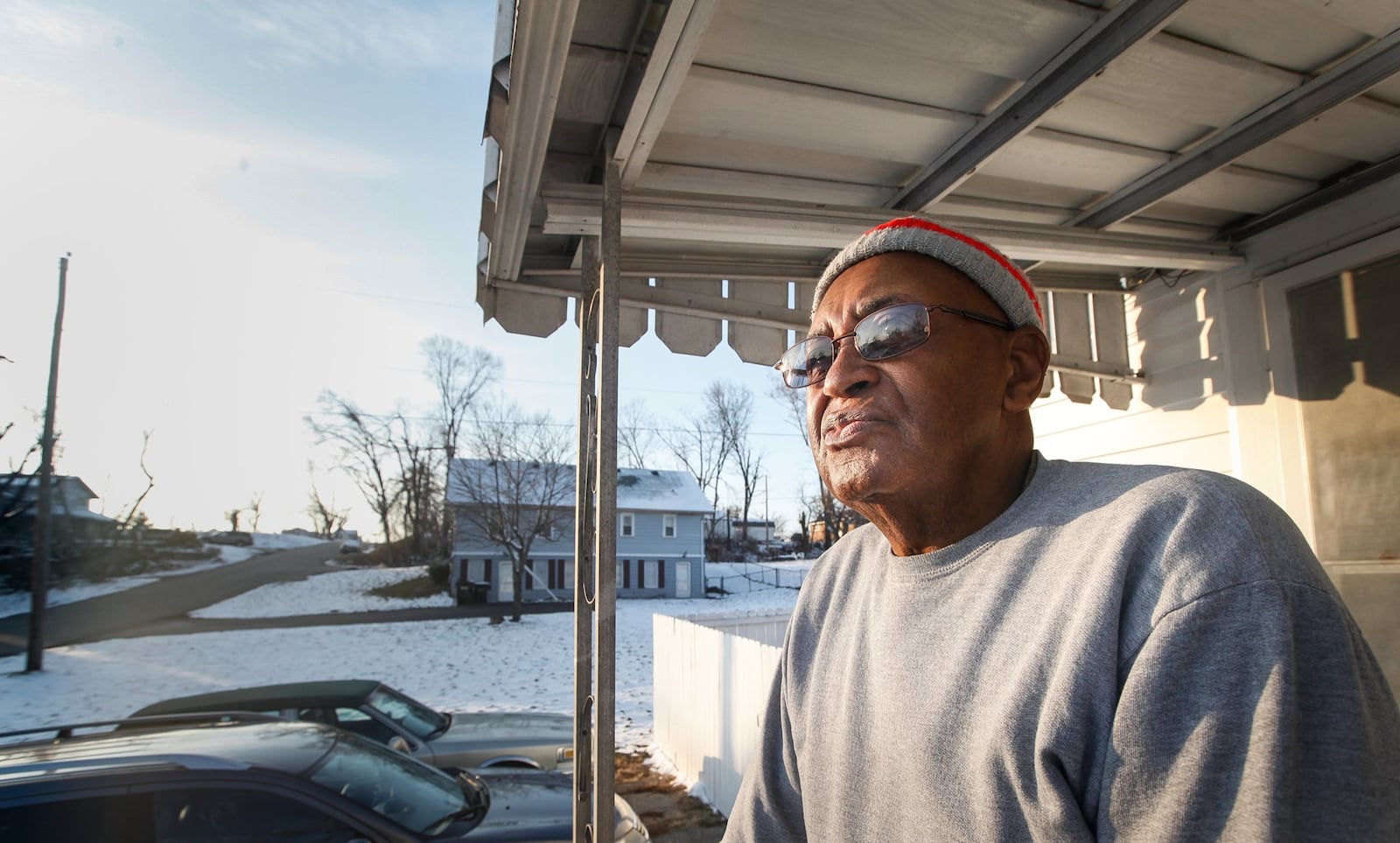 Jim Carr looks from his house on Maplegrove Avenue in Harrison Twp. where within a two-block area, seven tornado-abandoned properties remain untouched and are on a list for the township to demolish using potential FEMA funds. CHRIS STEWART / STAFF