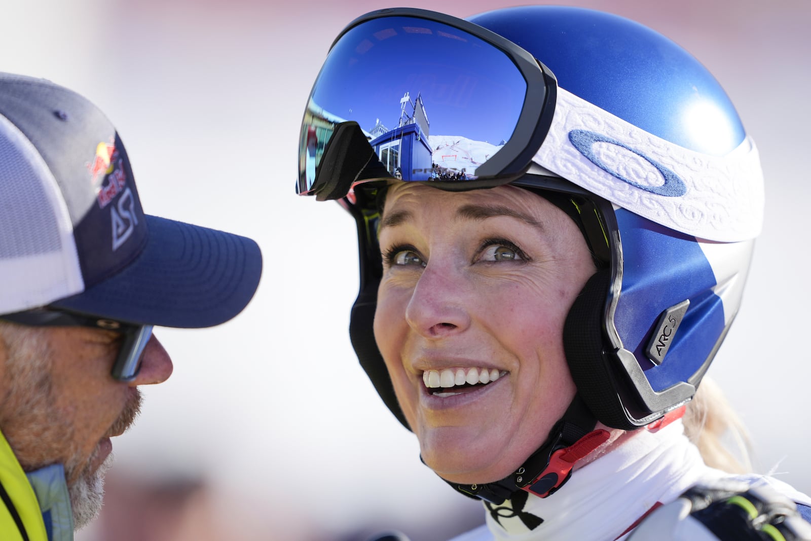 United States' Lindsey Vonn, right, smiles after completing an alpine ski, women's World Cup super G, in St. Moritz, Switzerland, Saturday, Dec. 21, 2024. (Til Buergy/Keystone via AP)