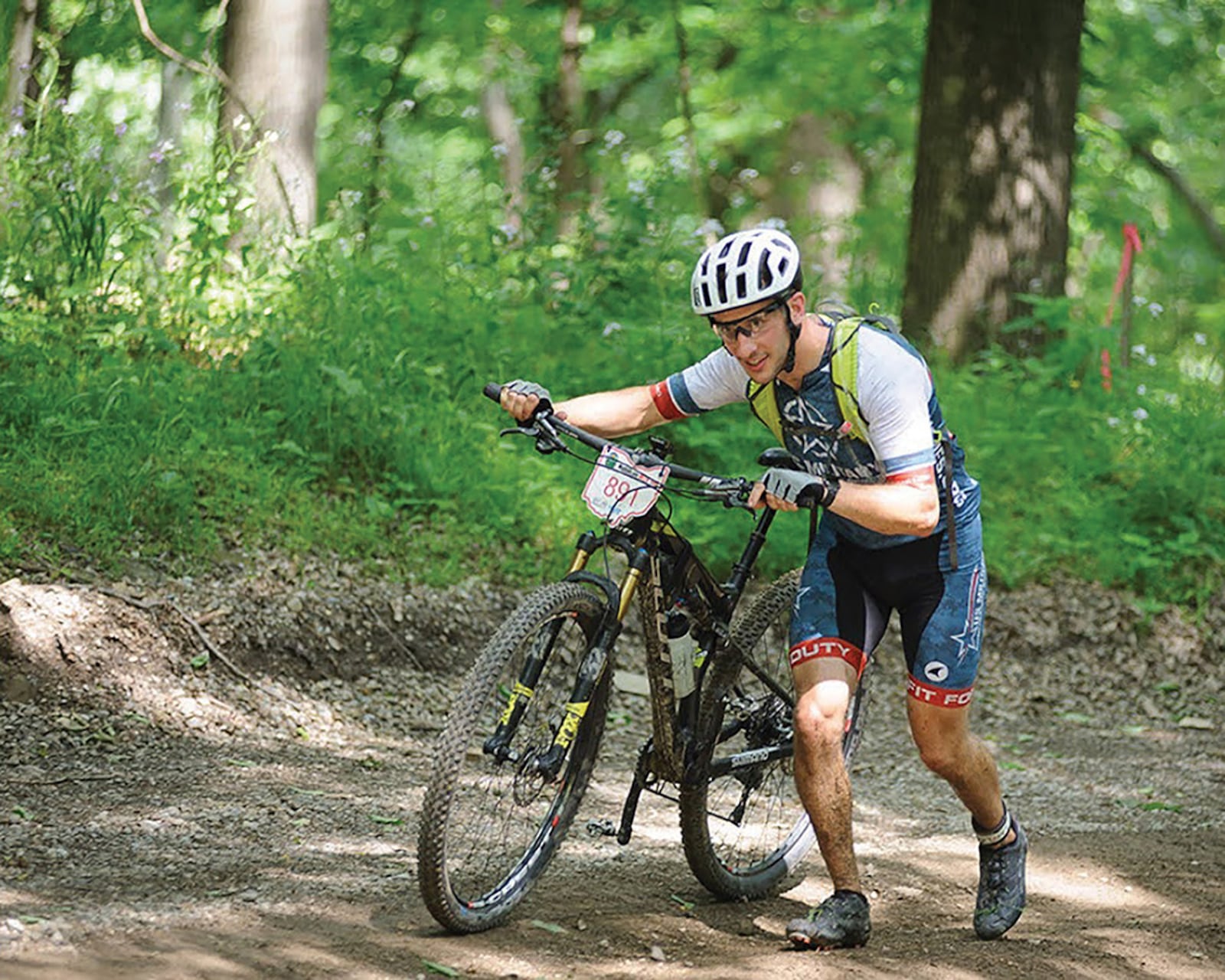 Six hours in, Master Sgt. Zachary Thorsky pushes his bike up a hill while tackling the final 7 to 8 miles of the Mohican 100 race last June in Loudonville. At Wright-Patterson Air Force Base, he serves as the 445th Airlift Wing’s Safety Office Flight NCO and staff unit fitness program manager. CONTRIBUTED PHOTO