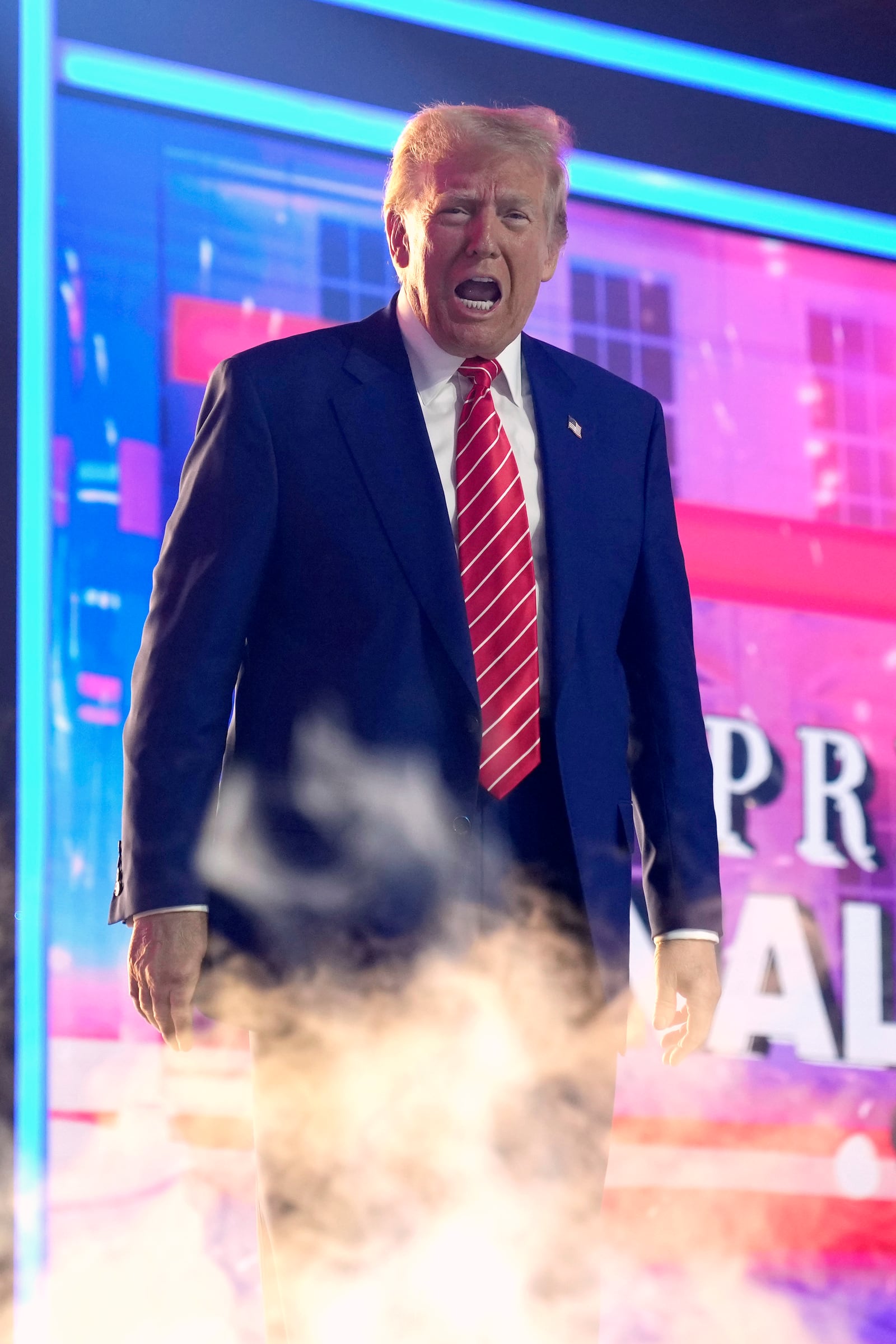 President-elect Donald Trump arrives on stage at AmericaFest, Sunday, Dec. 22, 2024, in Phoenix. (AP Photo/Rick Scuteri)