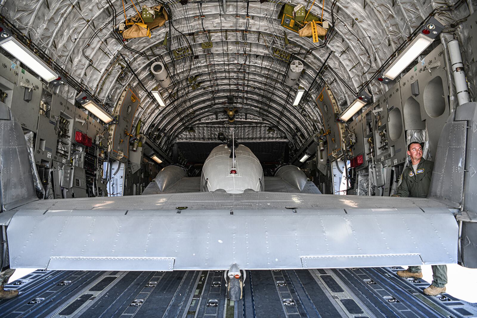 Tech. Sgt. Steven Murphy, 89th Airlift Squadron loadmaster, helps load a C-45H aircraft into the cargo area of a 445th Airlift Wing C-17 Globemaster III Sept. 30. U.S. AIR FORCE PHOTO/MASTER SGT. PATRICK O’REILLY