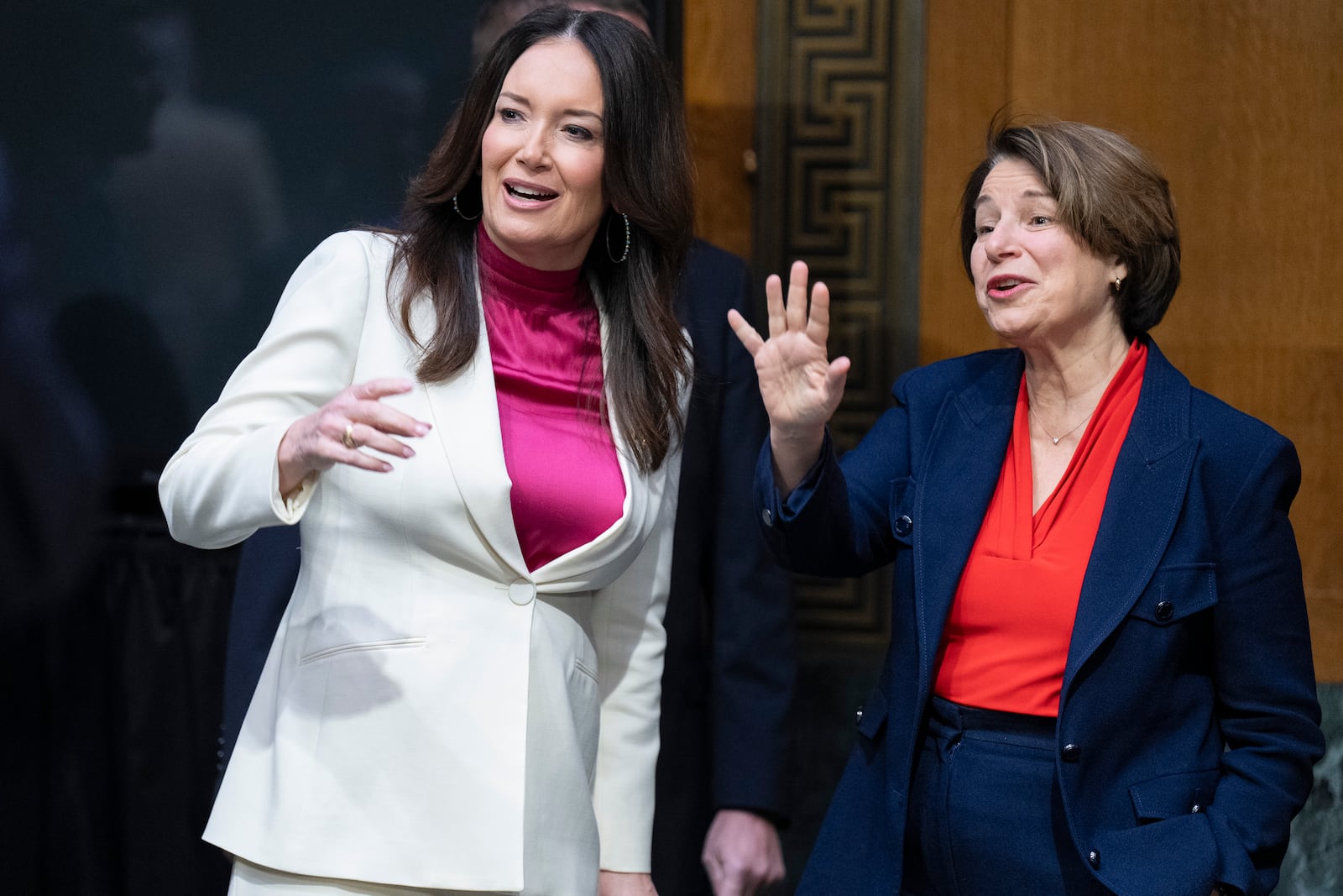 Brooke Rollins, left, and Senate Agriculture, Nutrition, and Forestry Committee Ranking Member Sen. Amy Klobuchar, D-Minn., greet people ahead of a committee hearing on Rollins' nomination for Secretary of Agriculture, Thursday, Jan. 23, 2025, in Washington. (AP Photo/Jacquelyn Martin)