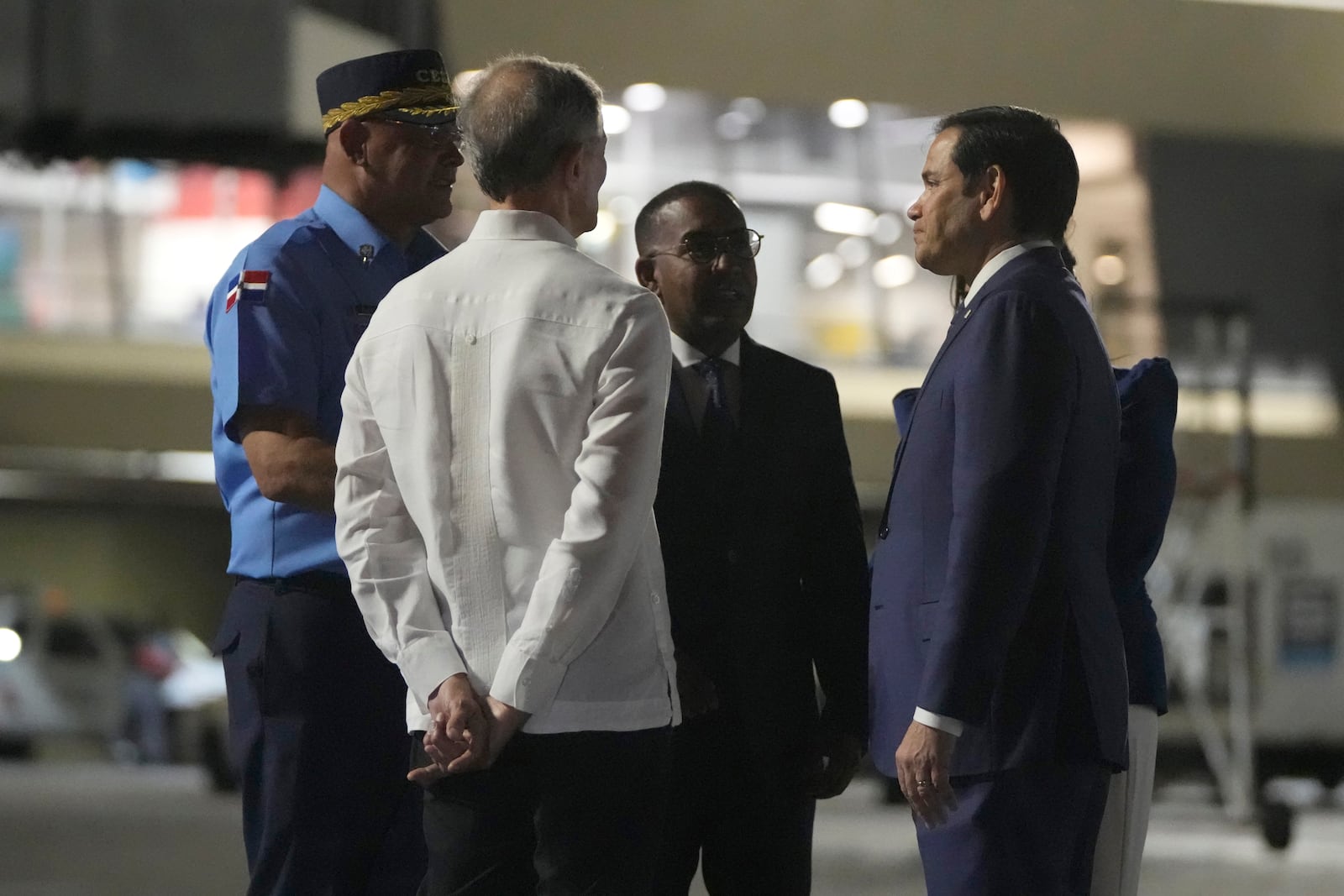 U.S. Secretary of State Marco Rubio is received by Foreign Minister Roberto Álvarez, second left, on the tarmac of Las Americas International Airport in Santo Domingo, Dominican Republic, Wednesday, Feb. 5, 2025. (AP Photo/Mark Schiefelbein, Pool)