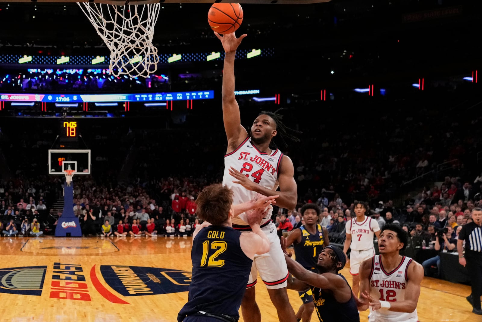 St. John's's Zuby Ejiofor (24) shoots over Marquette's Ben Gold (12) during the first half of an NCAA college basketball game in the semifinals of the Big East tournament Friday, March 14, 2025, in New York. (AP Photo/Frank Franklin II)