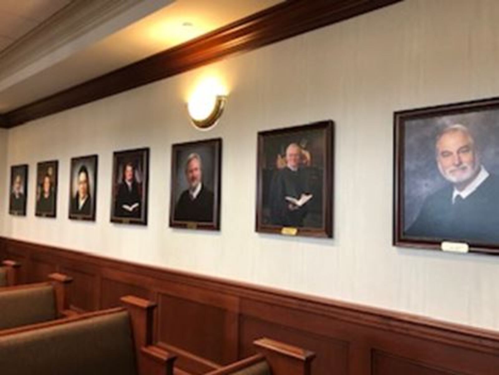 Portraits of former Butler County Common Pleas Judges line to will of the newly completed common pleas super courtroom. LAUREN PACK/Staff