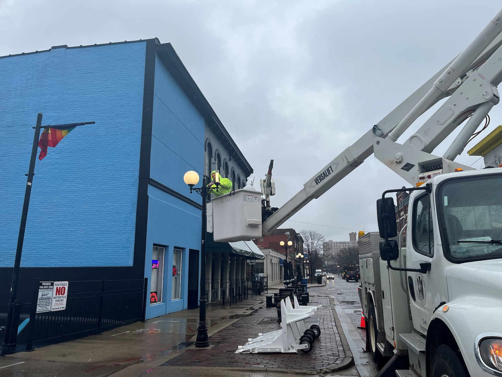 A city of Dayton employee works on a light pole in the Oregon District. CORNELIUS FROLIK / STAFF