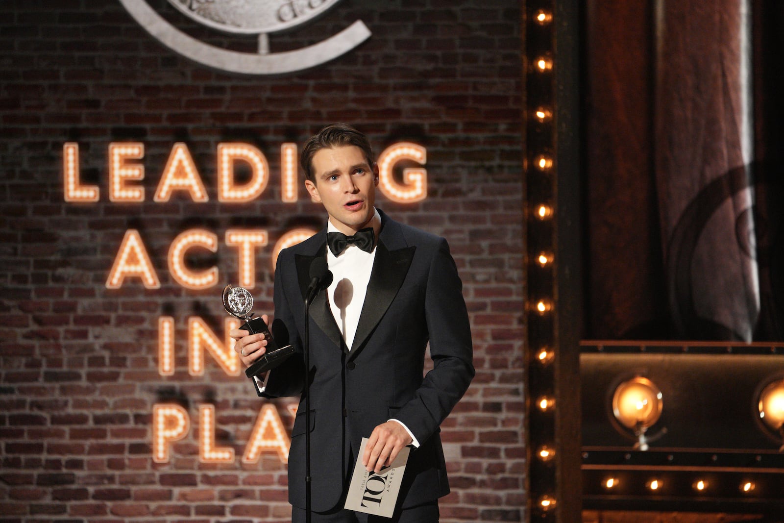 Andrew Burnap accepts the Tony Award for best performance by an actor in a leading role in a play for his performance in “The Inheritance,” at the 74th Annual Tony Awards in at the Winter Garden Theatre New York on Sunday night, Sept. 26, 2021. (Sara Krulwich/The New York Times)