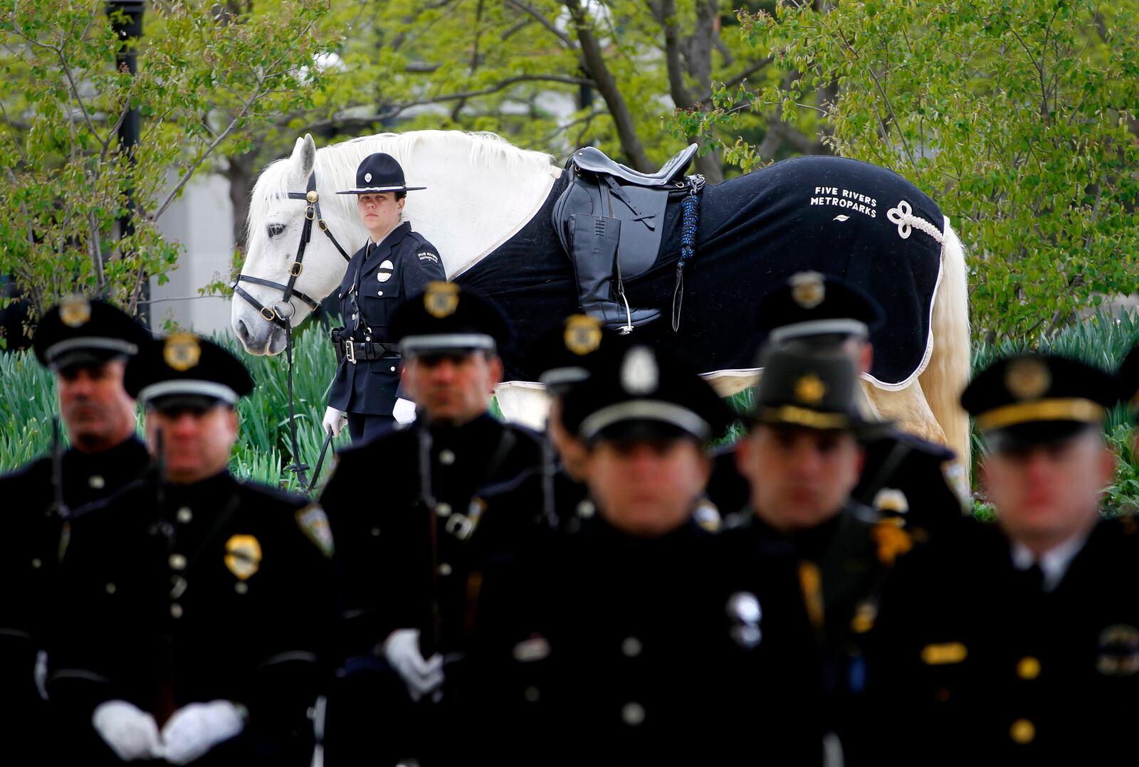 Five Rivers MetroParks Officer Deanna Flaugher lead a riderless horse at the 8th annual Montgomery County Law Enforcement Memorial Ceremony Friday in Dayton. The event honors the 38 Montgomery County law enforcement officers who have died in the line of duty. LISA POWELL / STAFF