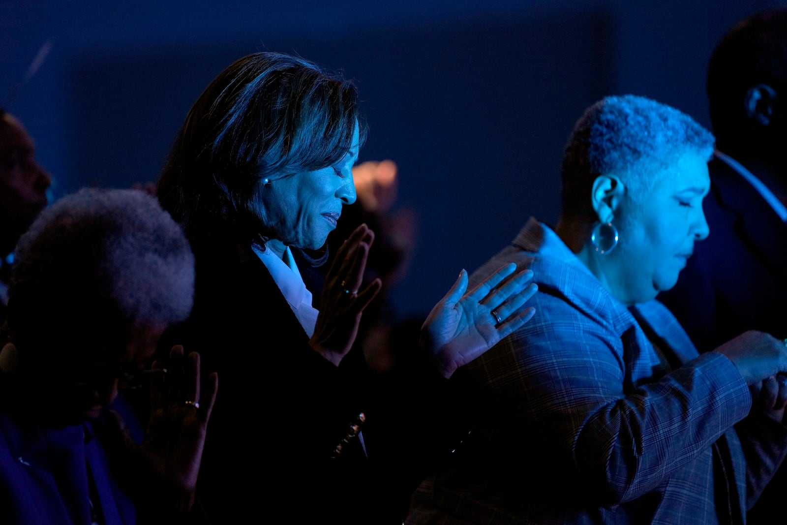 Democratic presidential nominee Vice President Kamala Harris, left, prays during a church service at Koinonia Christian Center in Greenville, N.C., Sunday, Oct. 13, 2024. (AP Photo/Susan Walsh)