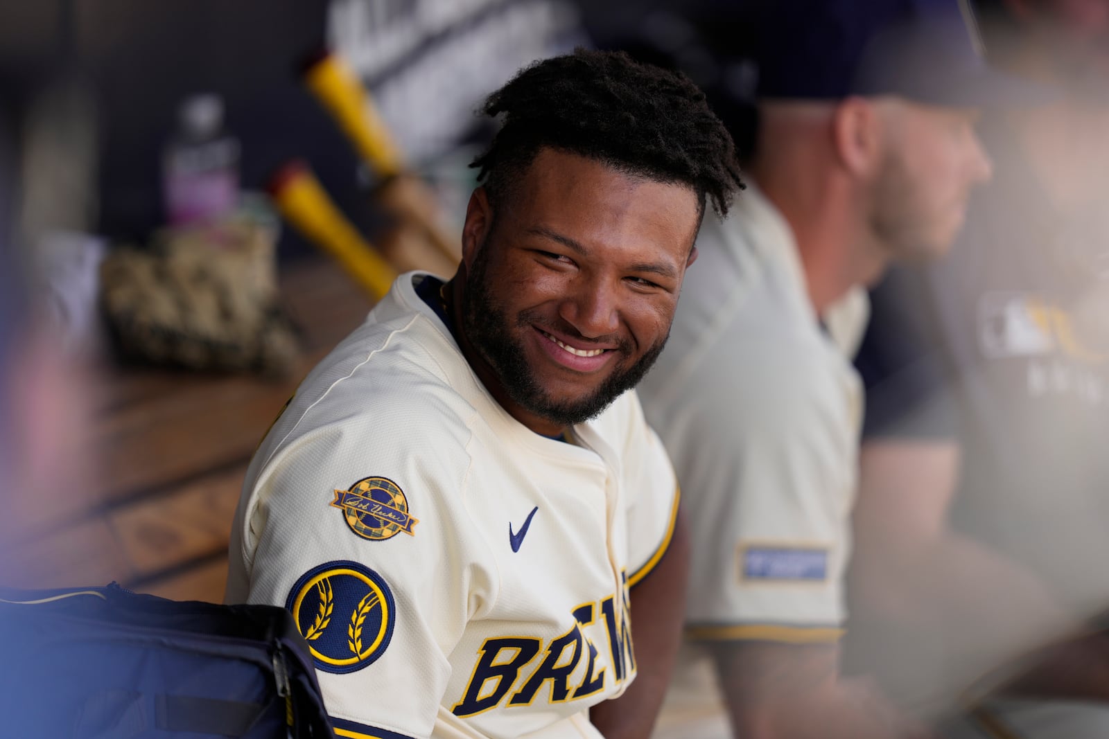 Milwaukee Brewers' Jackson Chourio smiles in the dougout during the fourth inning of a spring training baseball game against the Kansas City Royals , Thursday, Feb. 27, 2025, in Phoenix. (AP Photo/Carolyn Kaster)