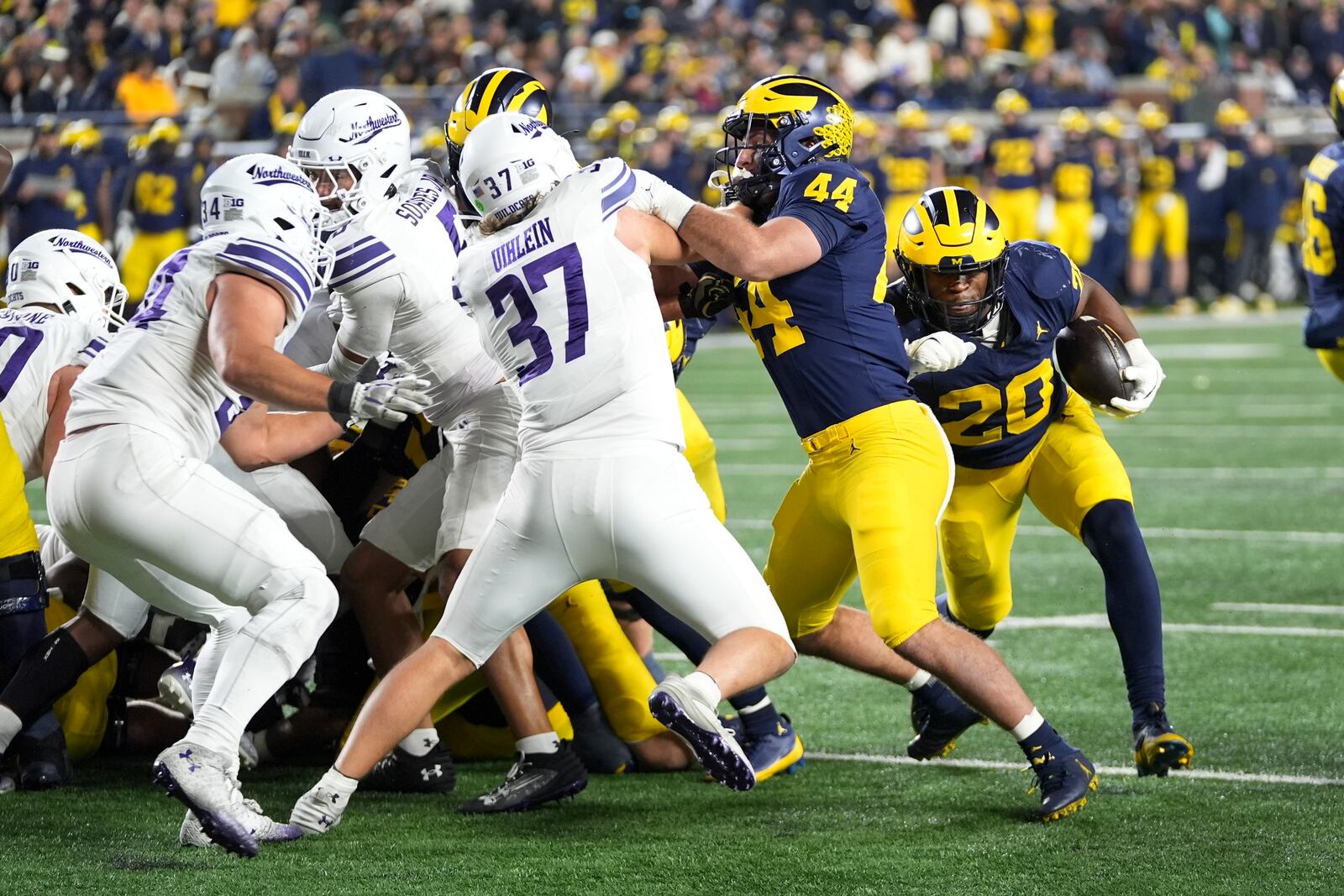 Michigan running back Kalel Mullings (20) runs the ball against Northwestern in the second half of an NCAA college football game in Ann Arbor, Mich., Saturday, Nov. 23, 2024. (AP Photo/Paul Sancya)