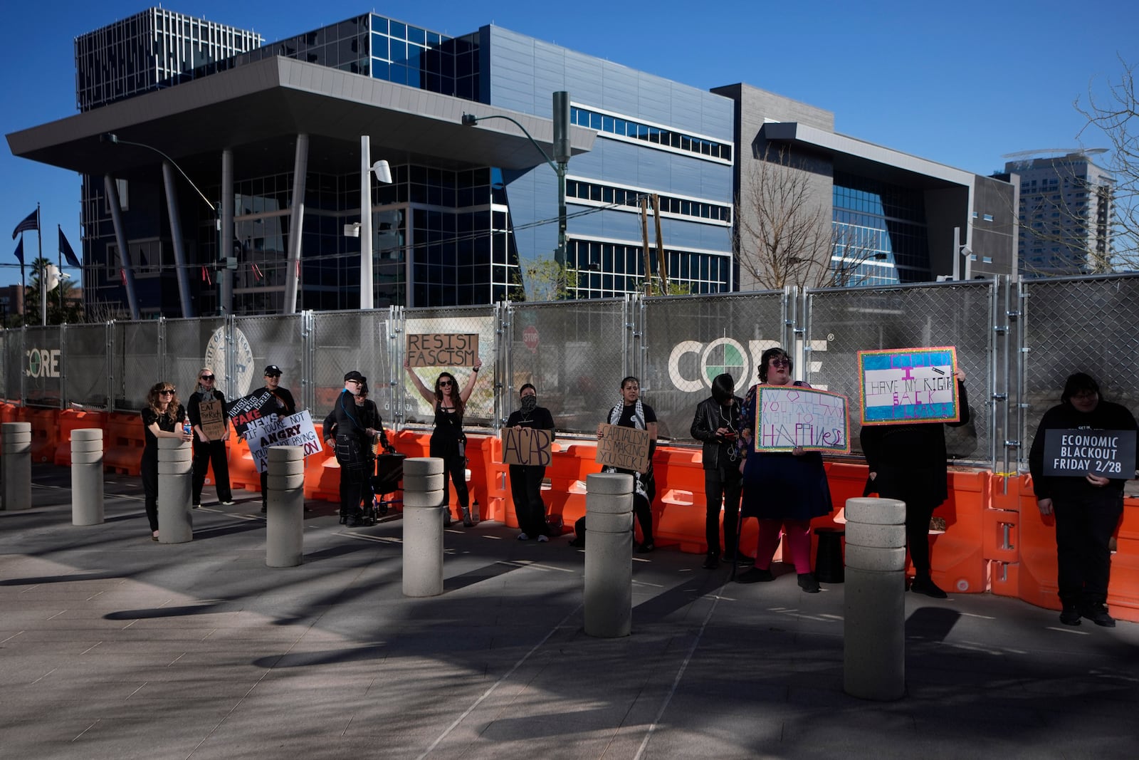 Protestors hold signs during a rally for a nationwide economic blackout Wednesday, Feb. 26, 2025, in Las Vegas. (AP Photo/John Locher)