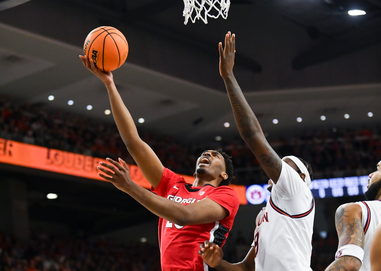 Georgia forward Justin Abson (25) shoots past Auburn forward Ja'Heim Hudson (8) during the first half an NCAA college basketball game Saturday, Feb. 22, 2025, in Auburn, Ala. (AP Photo/Julie Bennett)