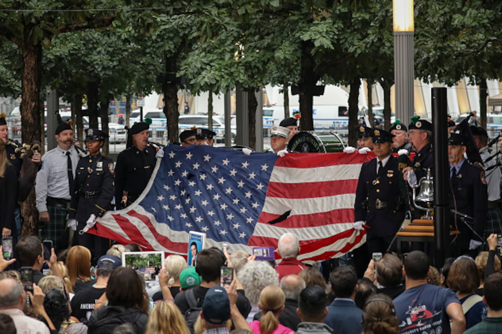 NEW YORK, NY - SEPTEMBER 11:  Firefighters hold up a flag that flew at the World Trade Center at the start of a commemoration ceremony for the victims of the September 11 terrorist attacks at the National September 11 Memorial, September 11, 2018 in New York City.  In New York City and throughout the United States, the country is marking the 17th anniversary of the September 11 terrorist attacks. (Photo by Drew Angerer/Getty Images)