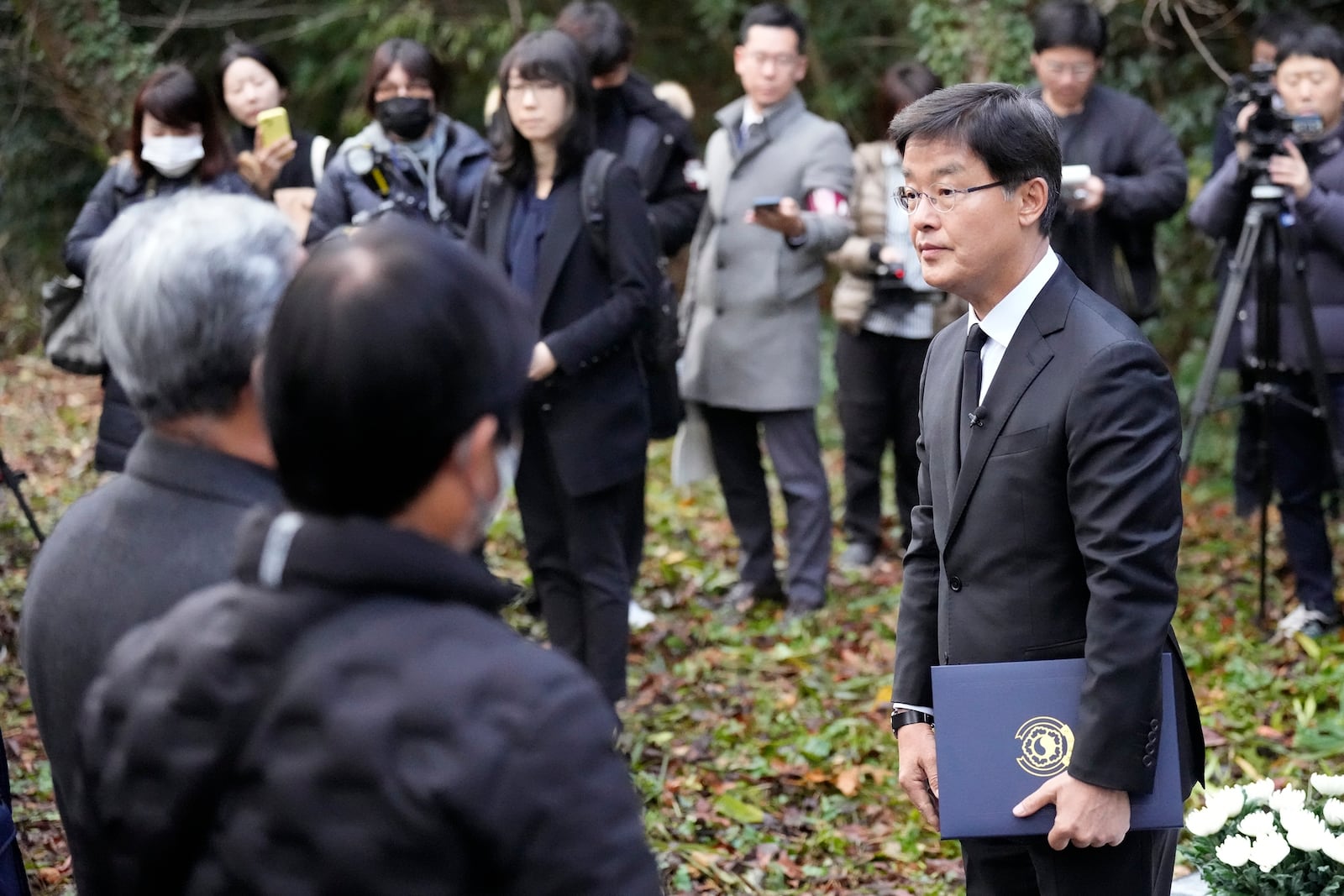 South Korean Ambassador to Japan Park Cheol-hee, right, delivers a speech to the relatives of Korean victims and South Korean officials during a memorial service at the site of former Fourth Souai Dormitory for the mine workers from the Korean Peninsula, in Sado, Niigata prefecture, Japan, Monday, Nov. 25, 2024. (AP Photo/Eugene Hoshiko)