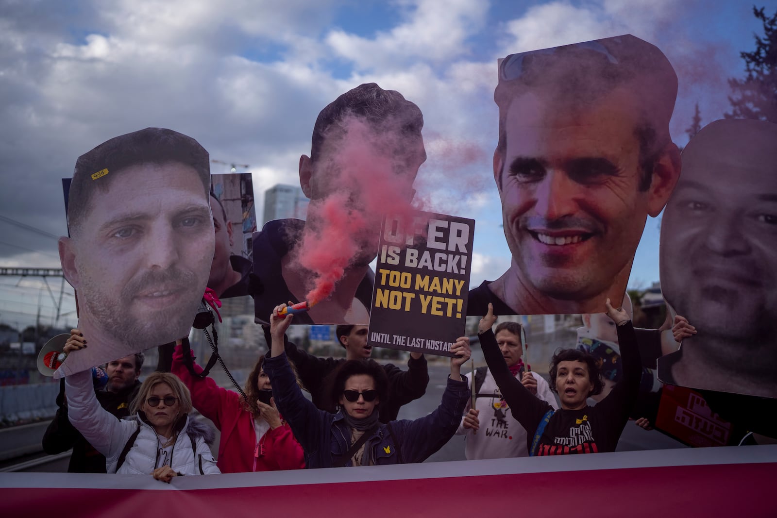 Relatives and supporters of Israelis held hostage in the Gaza Strip, hold photos depicting their faces during a protest demanding their release from Hamas captivity, in Tel Aviv, Israel, Thursday, Feb. 13, 2025. (AP Photo/Oded Balilty)