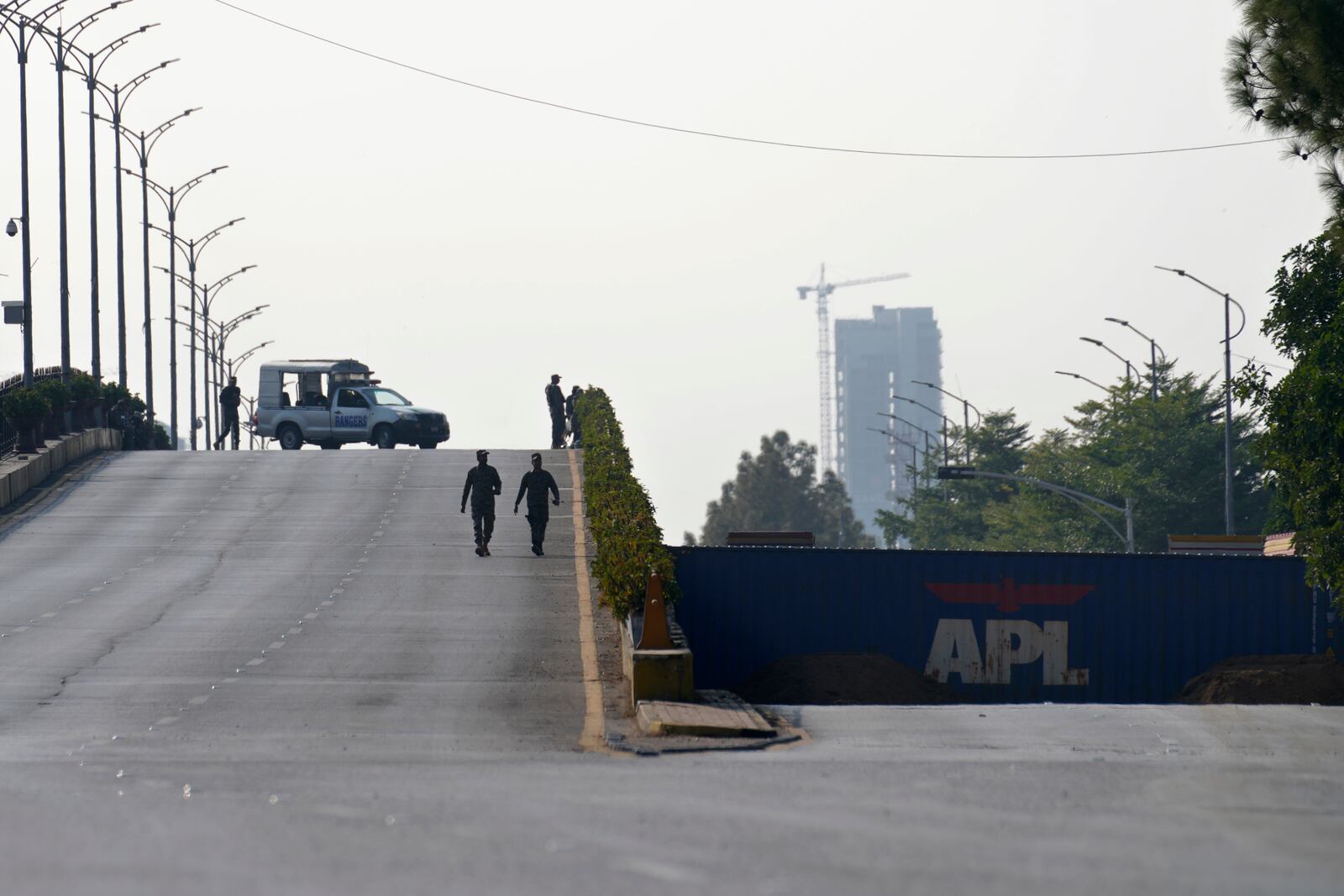 Paramilitary soldiers patrol as they station at a overhead bridge ahead of a planned rally by supporters of imprisoned former Prime Minister Imran Khan's Pakistan Tehreek-e-Insaf party, in Islamabad, Pakistan, Sunday, Nov. 24, 2024. (AP Photo/Anjum Naveed)