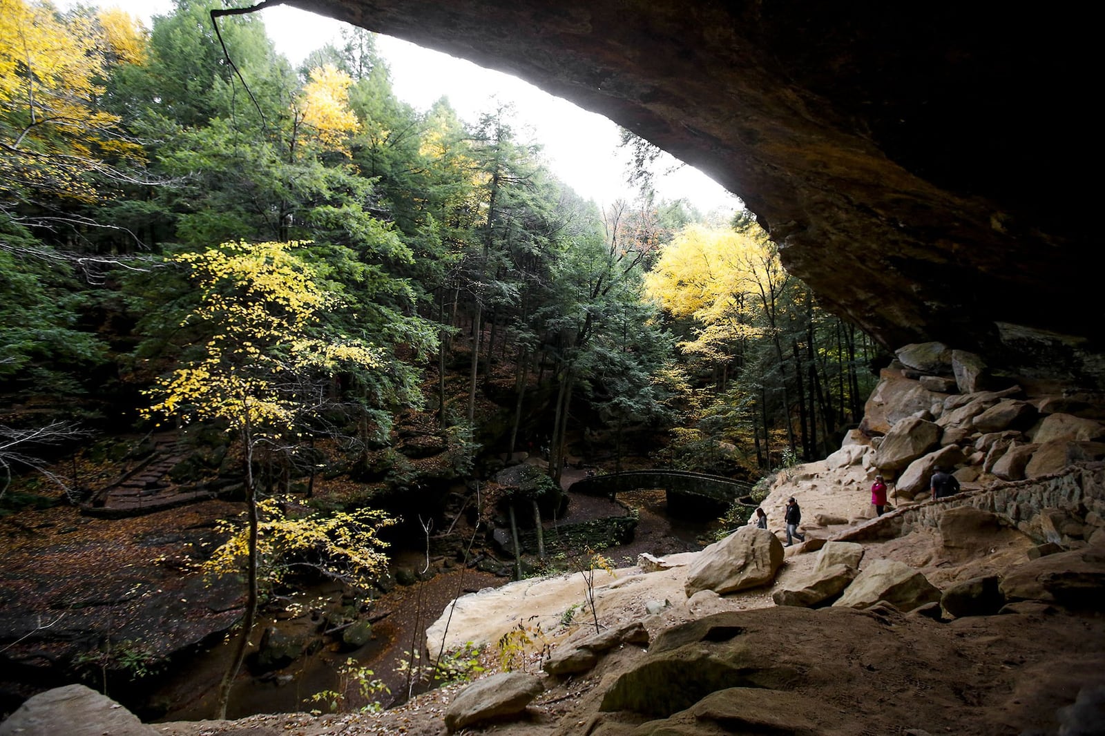 Hikers enjoy the fall foliage and explore Old Man’s Cave at Hocking Hills State Park last fall. (Kristen Zeis, Columbus Dispatch)