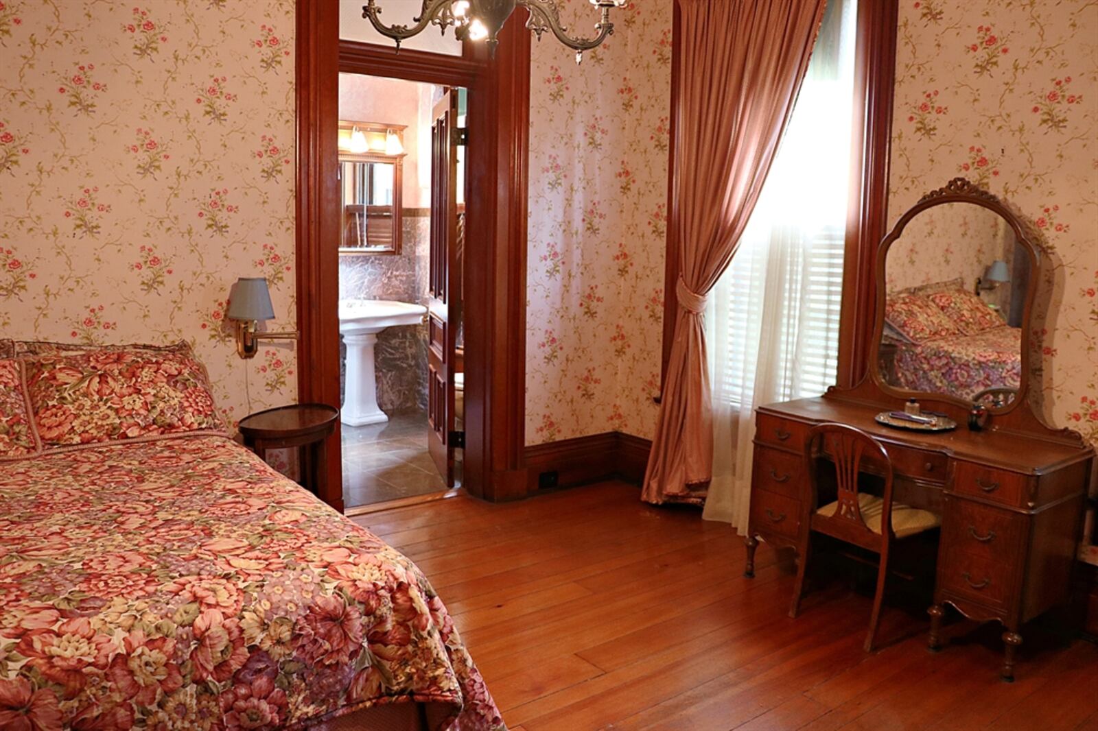 Two bedrooms have decorative marble fireplaces and deep single-door closets. 