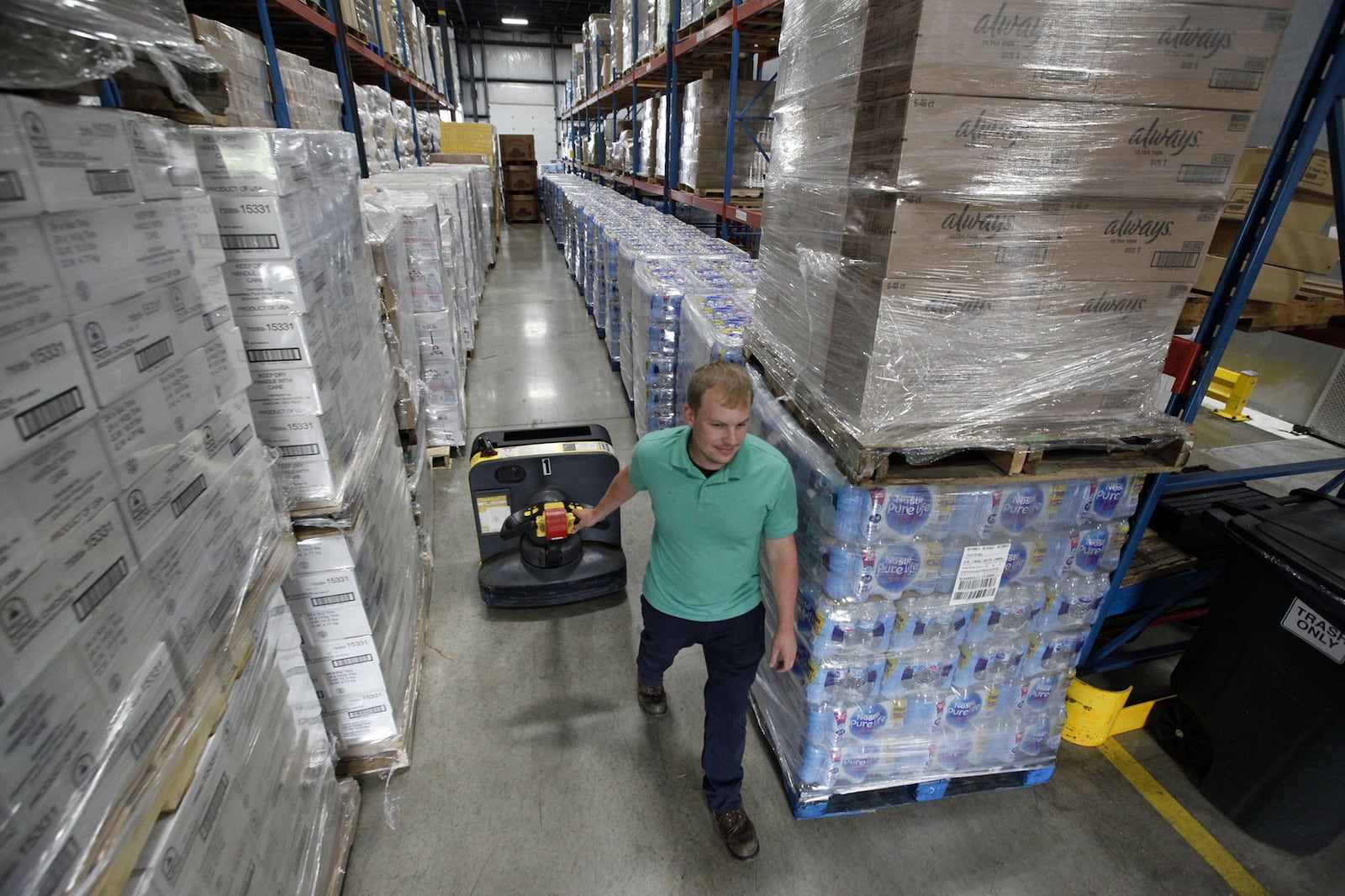 Matthew Roll returns a pallet truck down narrow aisle at The Foodbank where donations have filled the giant warehouse   in response to the needs of those displaced by tornados that ripped through the area on Memorial Day.  TY GREENLEES / STAFF