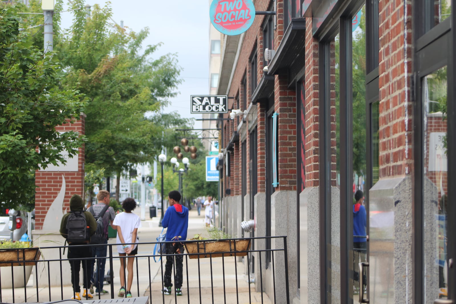 Kids walk along East Third Street in the Fire Blocks District. CORNELIUS FROLIK / STAFF