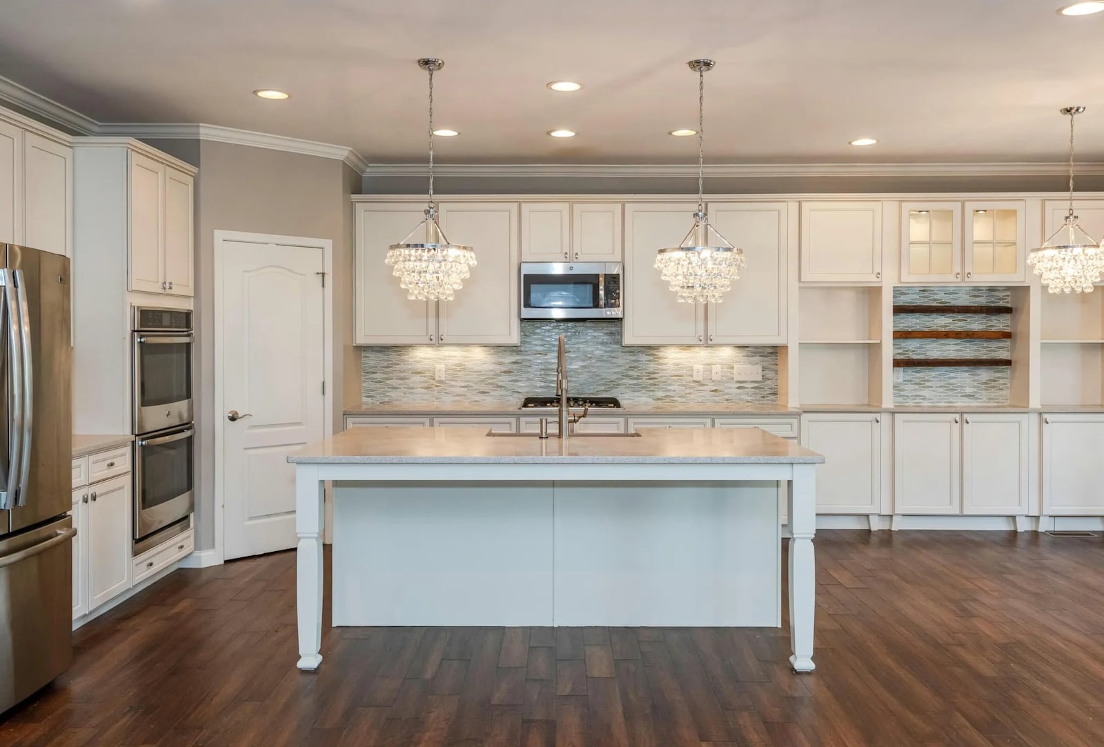 An island with table-leg accents and an extended granite counter allows for breakfast seating for up to four. CONTRIBUTED