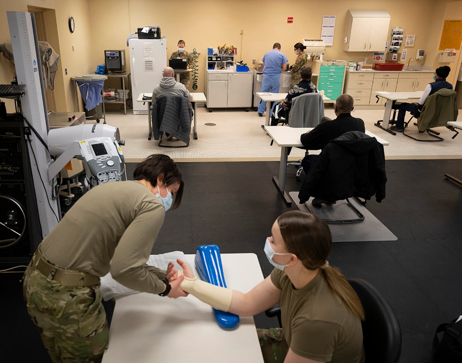 Capt. Emily Philips, 88th Operational Medical Readiness Squadron occupational therapist, demonstrates splinting a hand Jan. 25 on Airman 1st Class Leah Fitzke in Wright-Patterson Medical Center. U.S. AIR FORCE PHOTO/R.J. ORIEZ