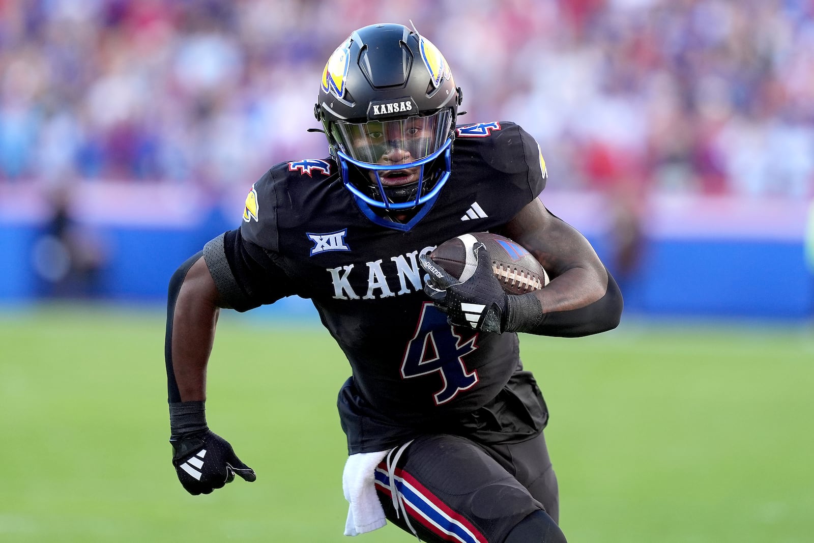 Kansas running back Devin Neal runs the ball during the first half of an NCAA college football game against Iowa State Saturday, Nov. 9, 2024, in Kansas City, Mo. (AP Photo/Charlie Riedel)