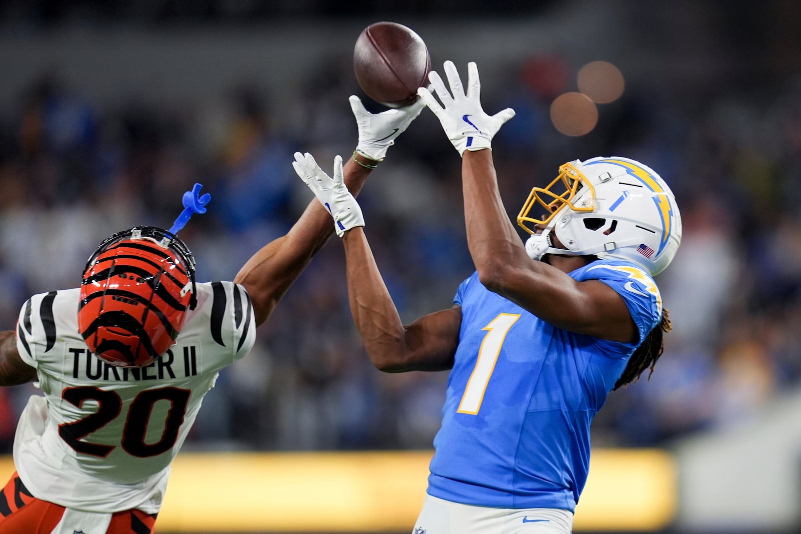 Cincinnati Bengals cornerback DJ Turner II (20) breaks up a pass intended for Los Angeles Chargers wide receiver Quentin Johnston (1) during the second half of an NFL football game Sunday, Nov. 17, 2024, in Inglewood, Calif. (AP Photo/Gregory Bull)