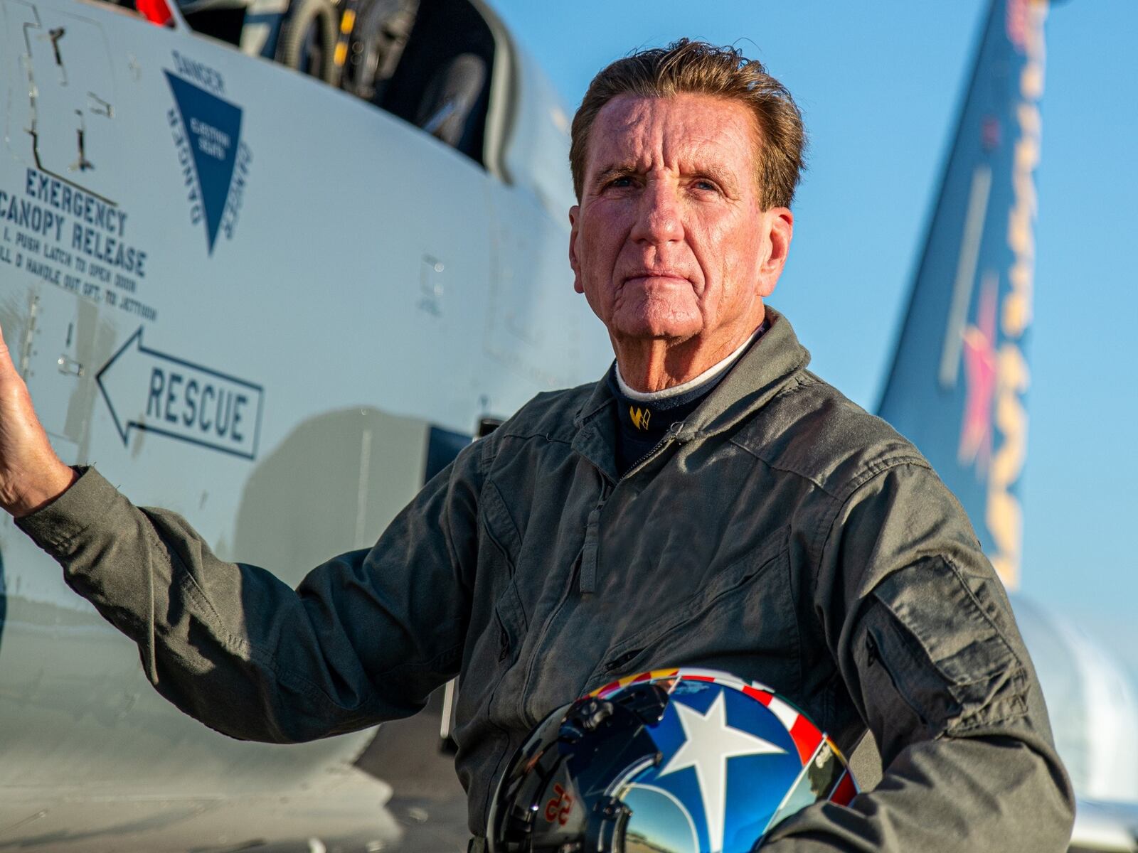 Larry Connor alongside F-5 fighter jet he has flown. CONTRIBUTED