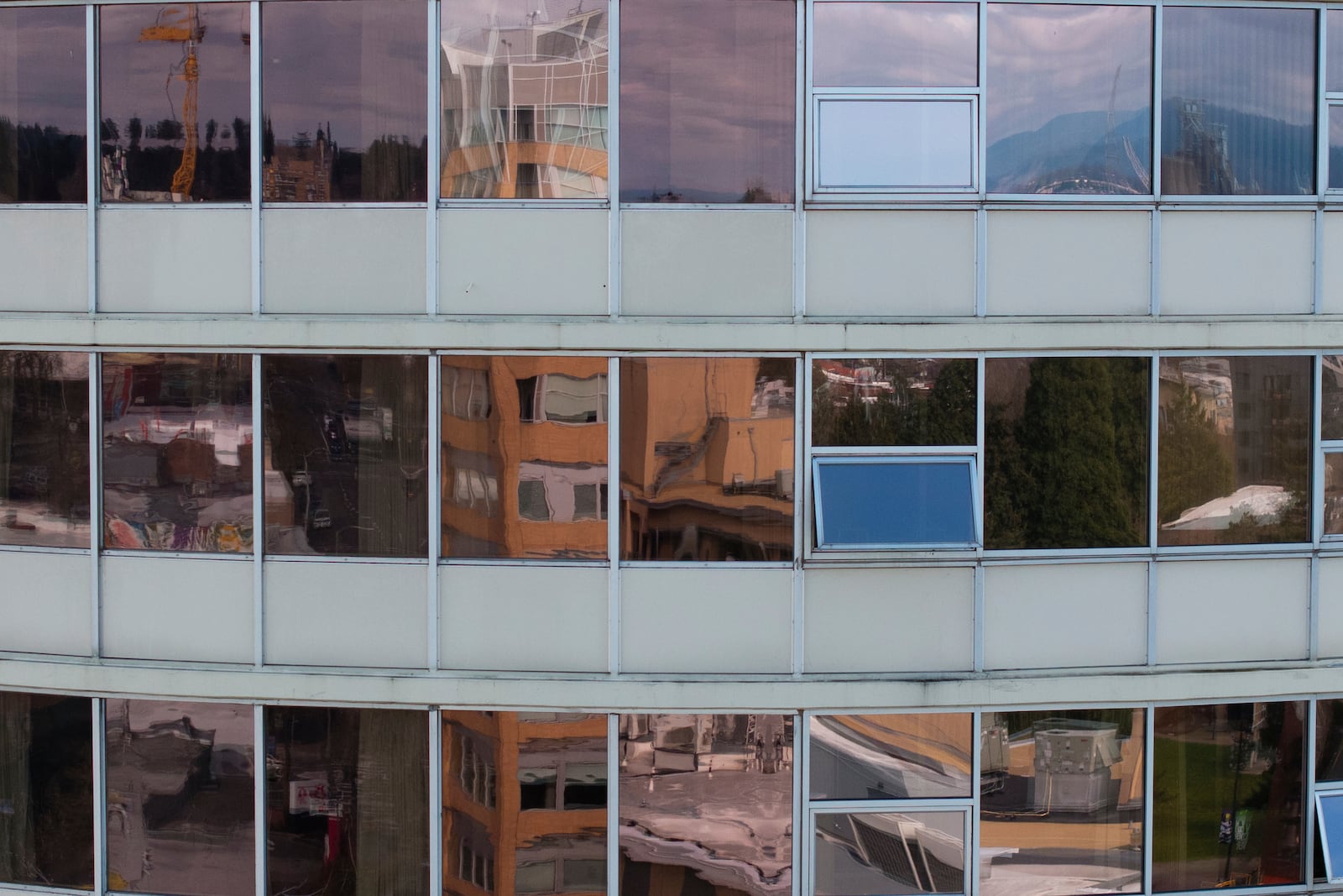 Windows at Smith Tower Apartments reflect the surroundings in Vancouver, Wash., on Monday, March 10, 2025. (AP Photo/Jenny Kane)