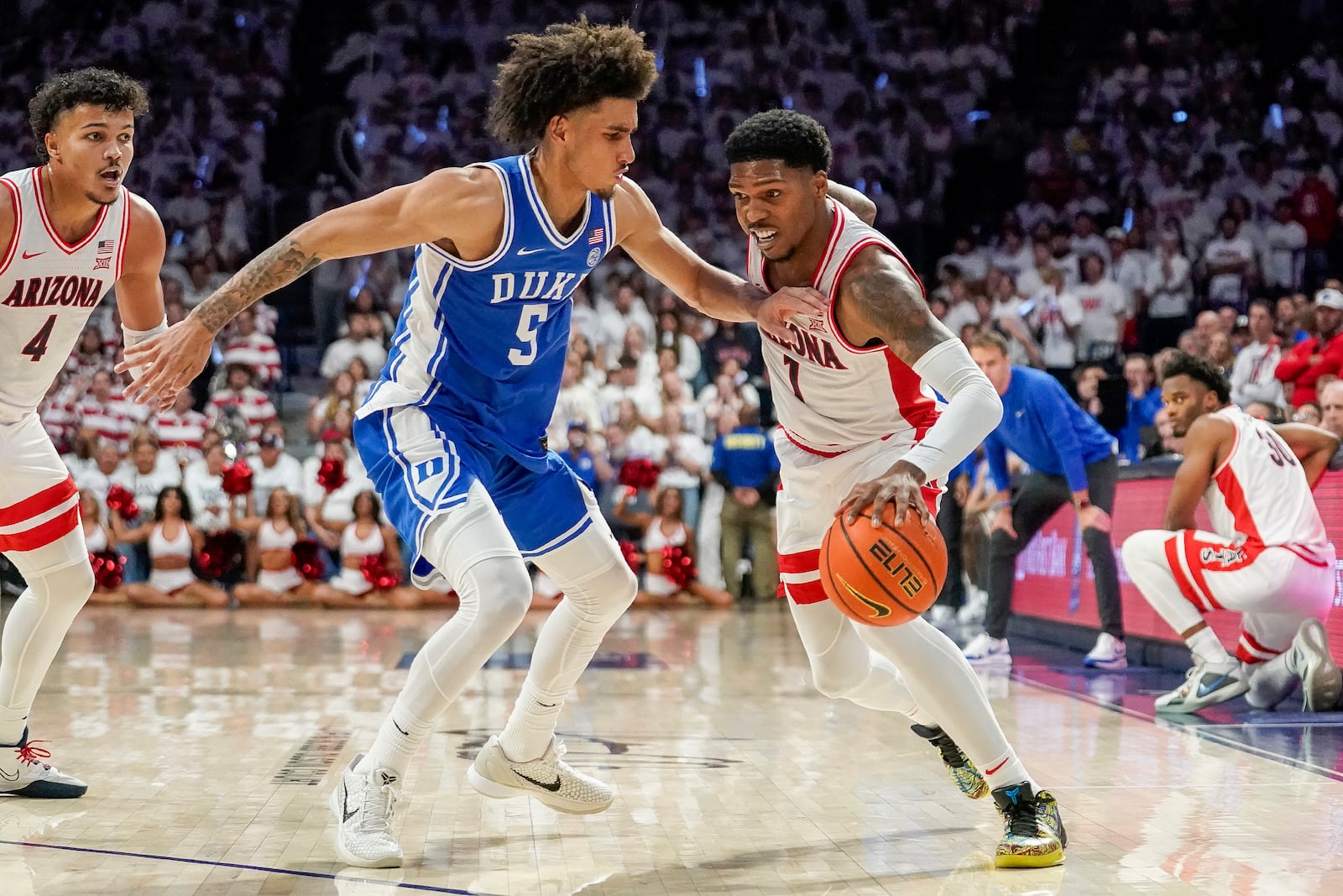 Arizona guard Caleb Love (1) tries to dribble around Duke guard Tyrese Proctor (5) during the second half of an NCAA college basketball game Friday, Nov. 22, 2024, in Tucson, Ariz. (AP Photo/Darryl Webb)