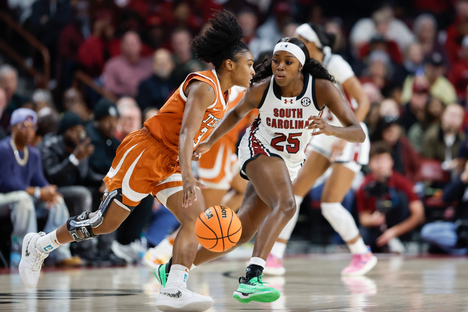 Texas guard Rori Harmon (3) drives against South Carolina guard Raven Johnson (25) during the first half of an NCAA college basketball game in Columbia, S.C., Sunday, Jan. 12, 2025. (AP Photo/Nell Redmond)