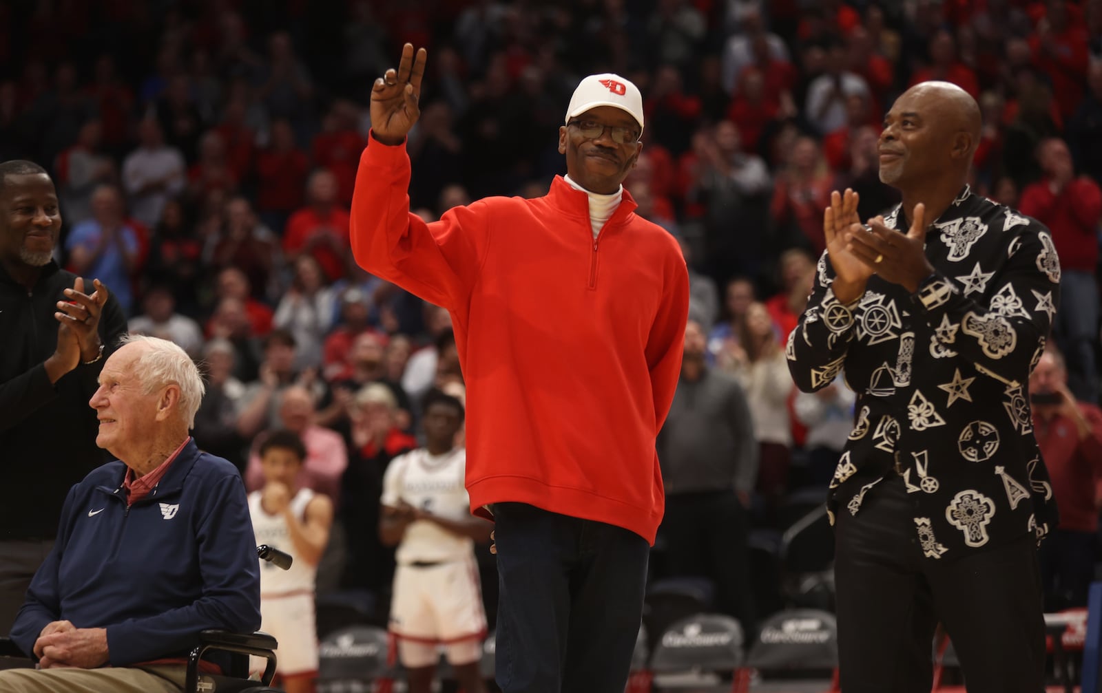 Roosevelt Chapman waves to the crowd during a ceremony honoring members of Dayton's 1984 Elite Eight team at halftime of a game against Grambling State on Saturday, Dec. 2, 2023, at UD Arena. David Jablonski/Staff