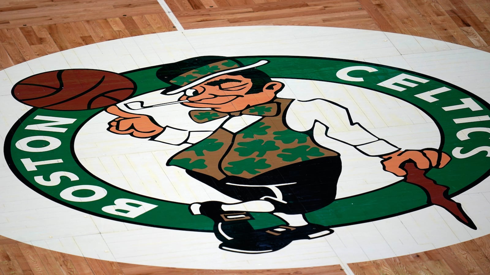 FILE - The Boston Celtics logo is seen at center court on the parquet floor before an NBA basketball game, Wednesday, April 28, 2021, in Boston. (AP Photo/Charles Krupa, File)