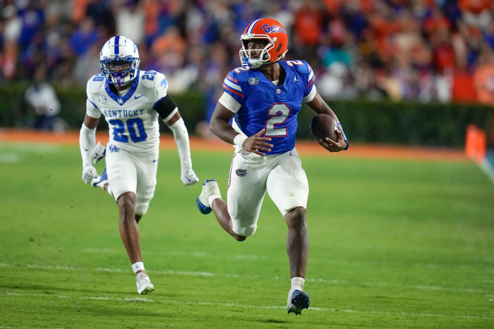 Florida quarterback DJ Lagway (2) runs past Kentucky defensive back Terhyon Nichols (20) during the first half of an NCAA college football game, Saturday, Oct. 19, 2024, in Gainesville, Fla. (AP Photo/John Raoux)